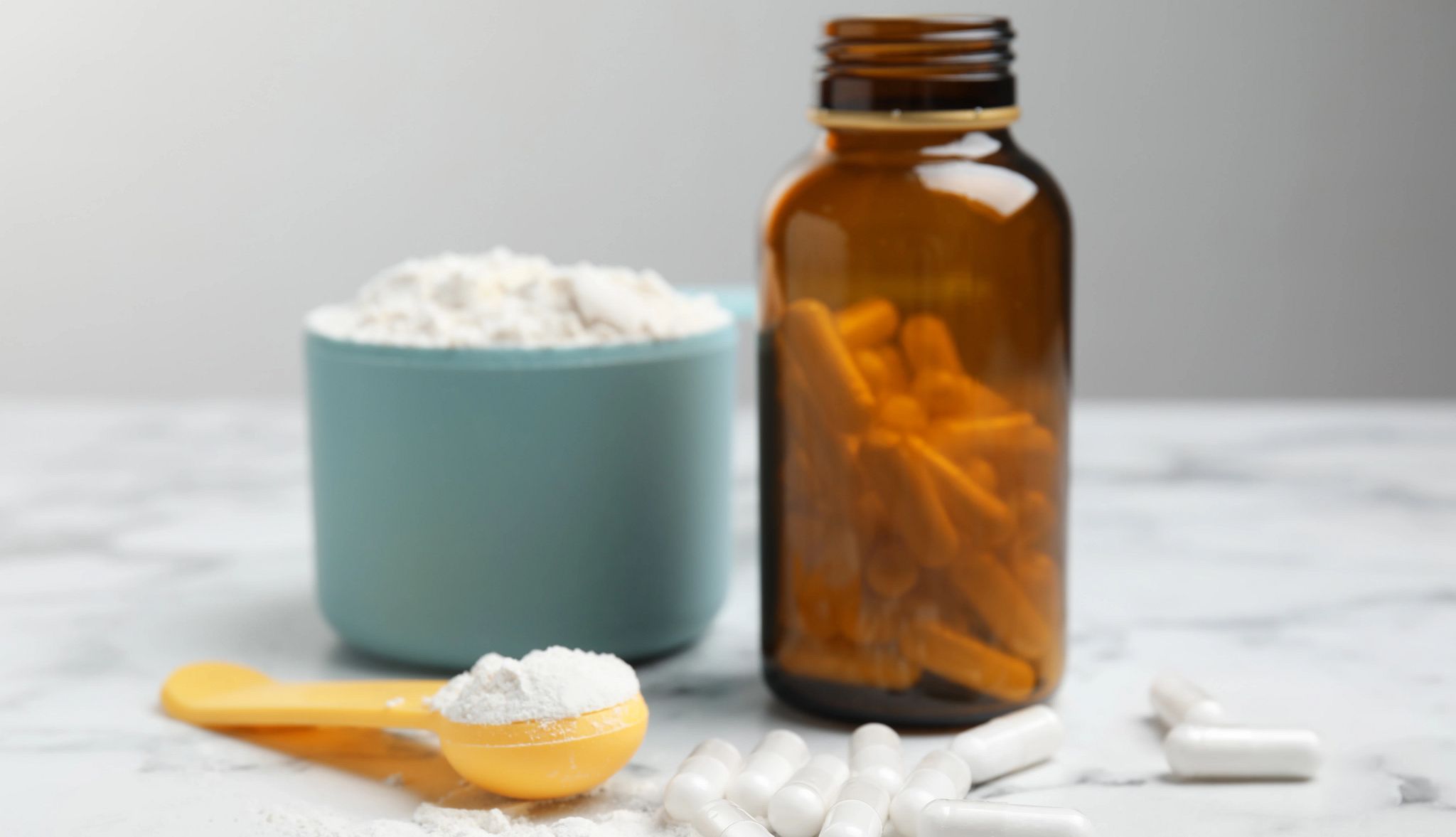 A recent study suggests creatine might slow down or stave off Alzheimer's disease Amino acid pills and powder on a white marble table