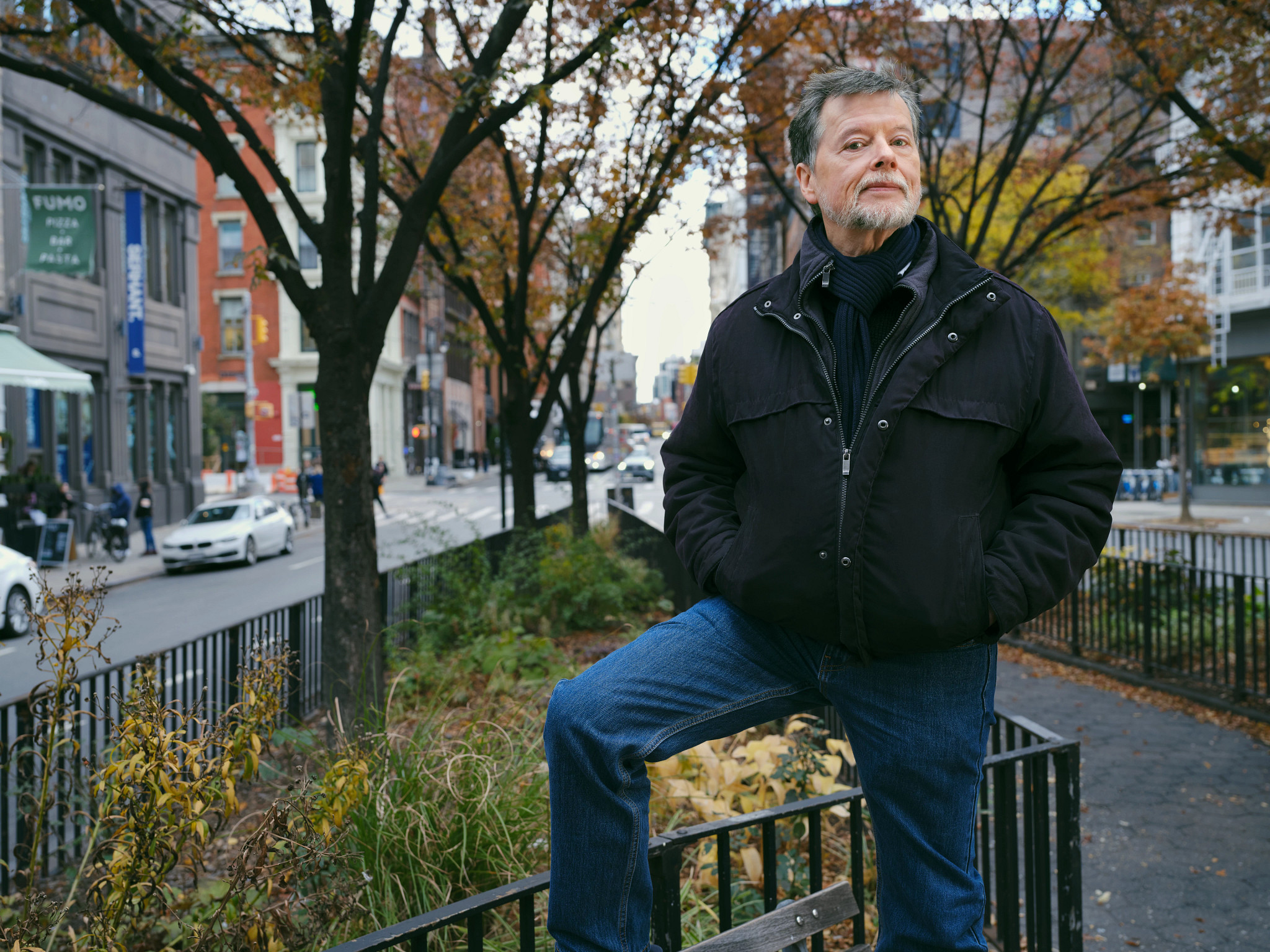 ken burns posing for an outdoor portrait in a black jacket