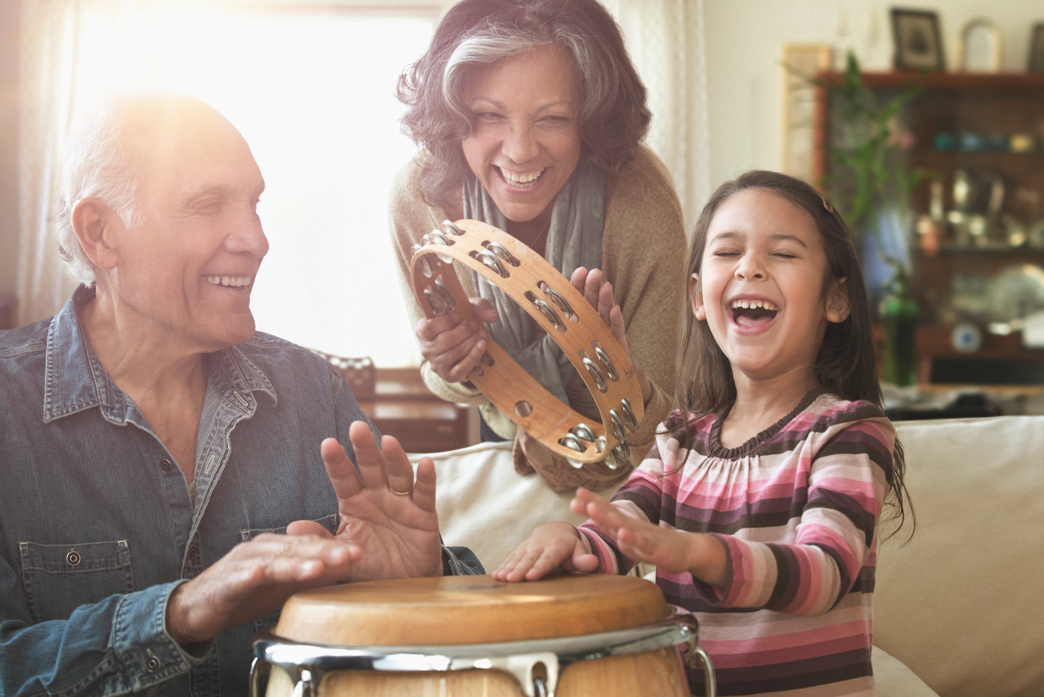 Grandparents and granddaughter playing music together