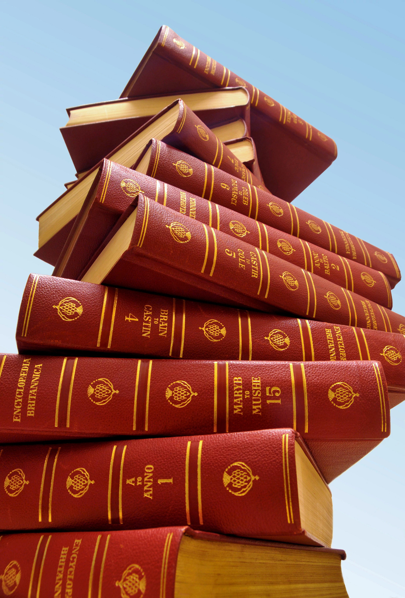 stack of encylopedia britanicas on a blue background