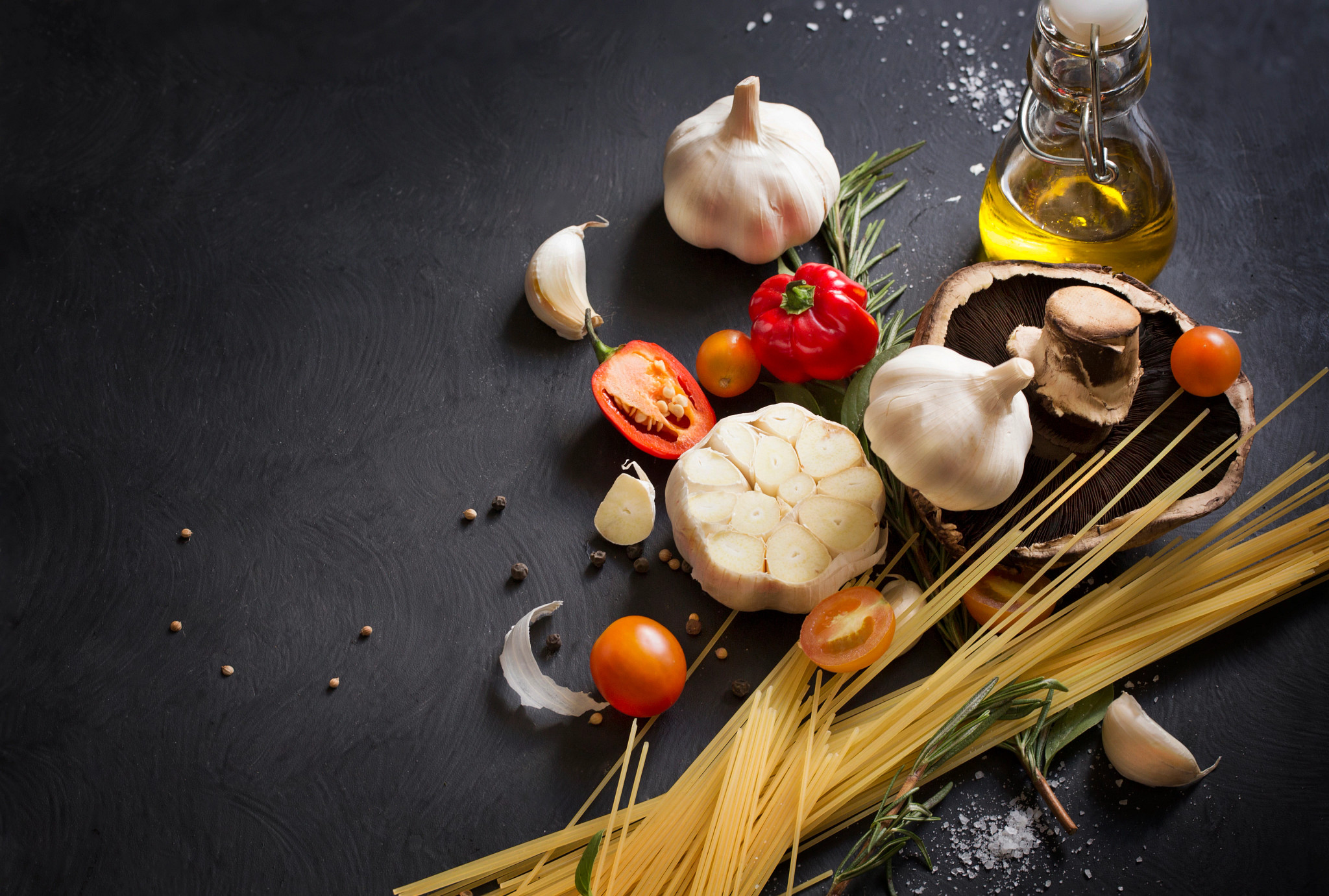  spaghetti recipe ingredient on black texture background.