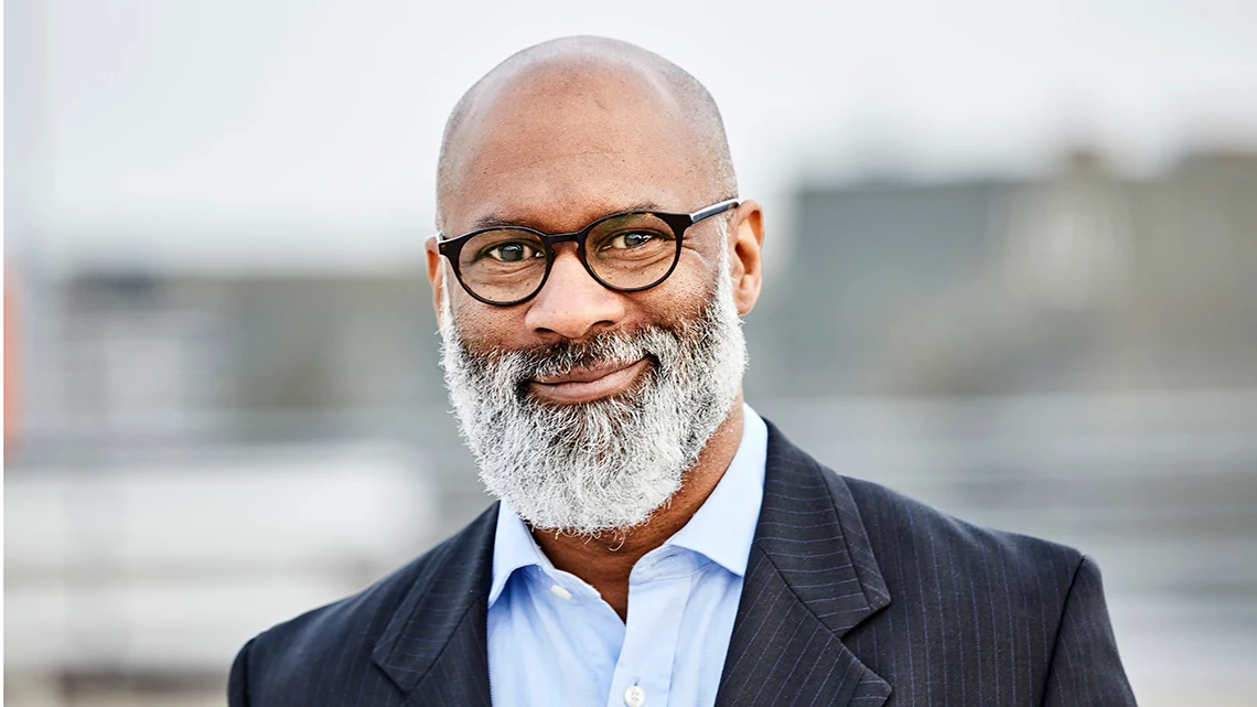 LensCrafters Mature, bearded, African American man with black frame glasses