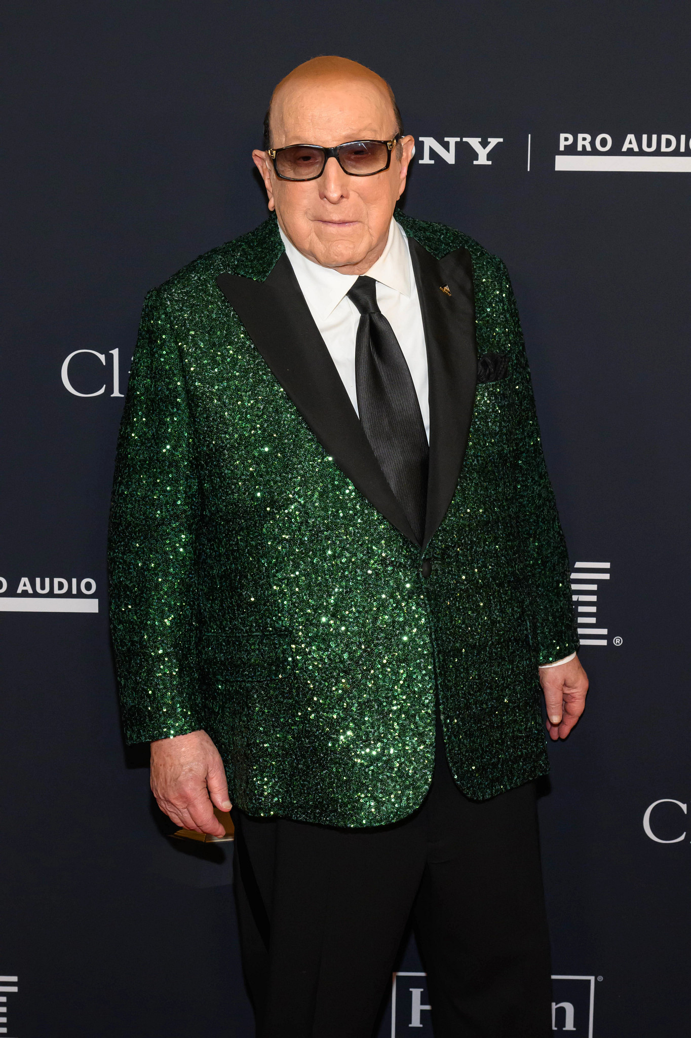 clive davis in glasses and a suit