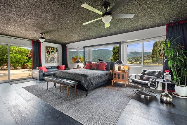 a bedroom with black and red decor