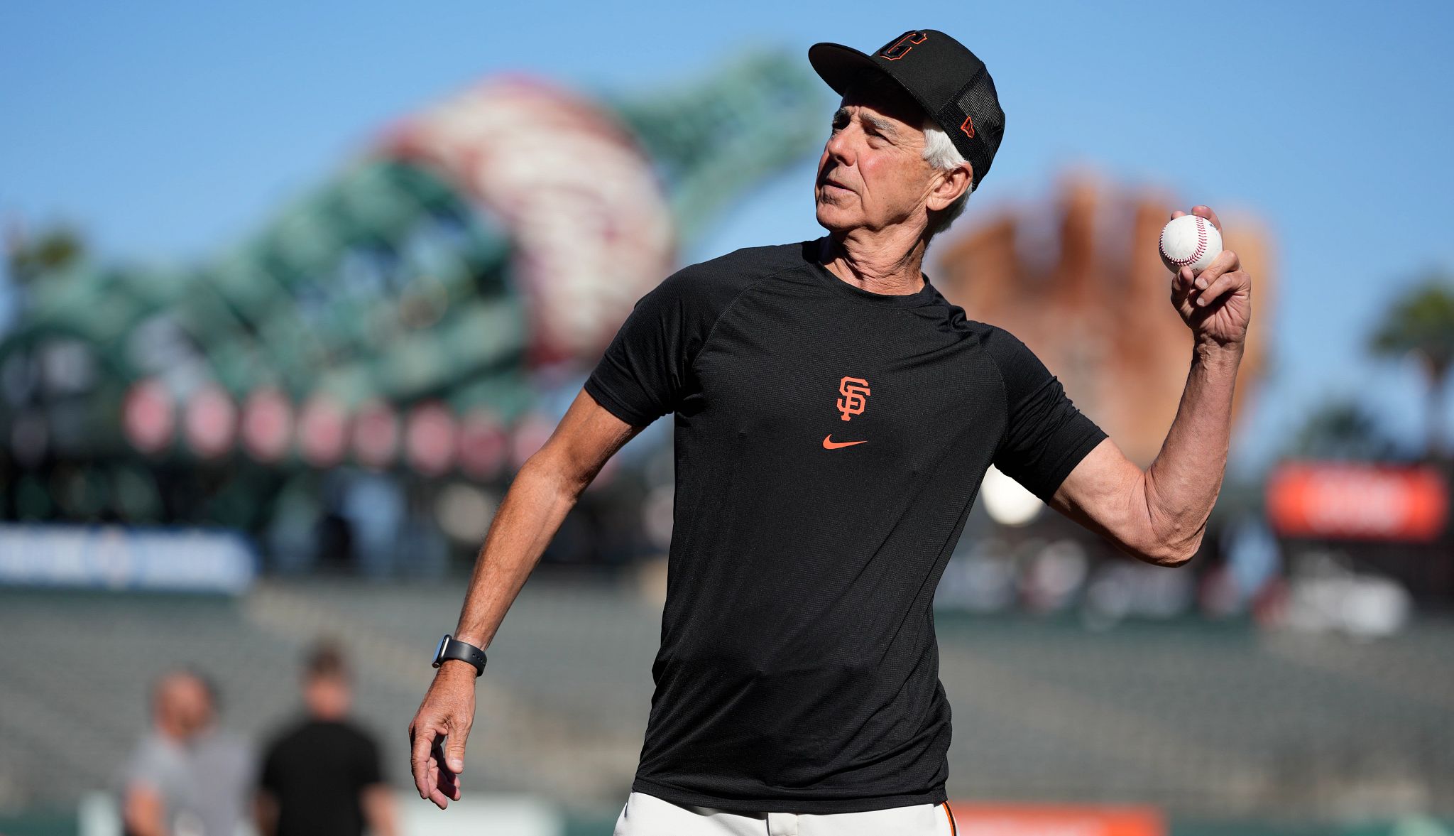 Pitching to Major Leaguers at 70 A photograph shows real estate executive John Yandle throwing a baseball at Oracle Park in San Francisco.