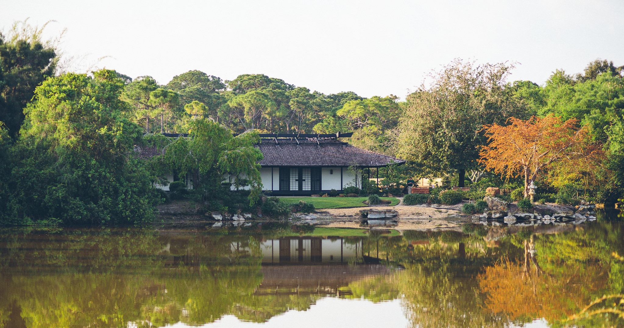 a building near water at a japanese garden
