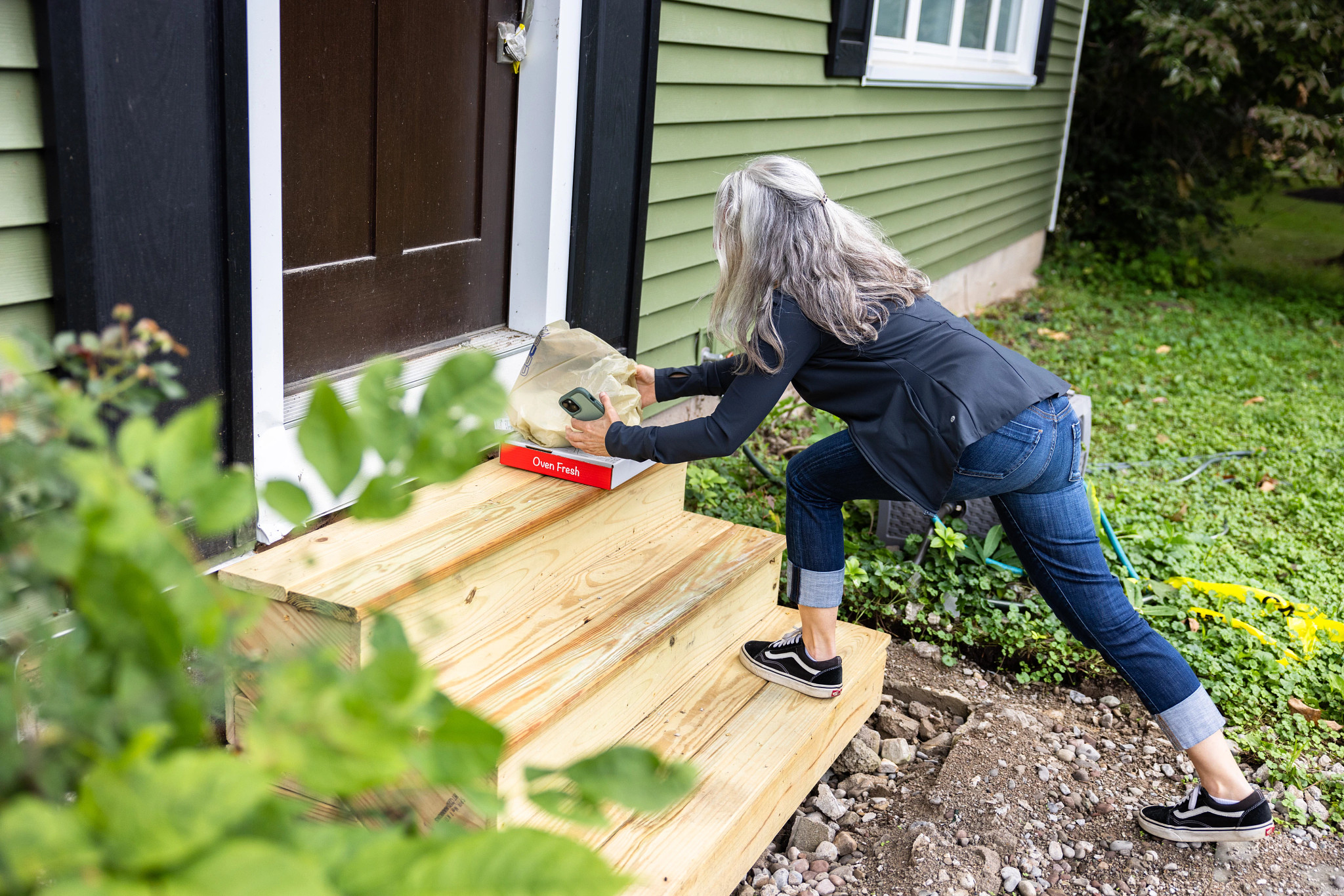 Robin Flanigan dropping off a delivery at a person's front door