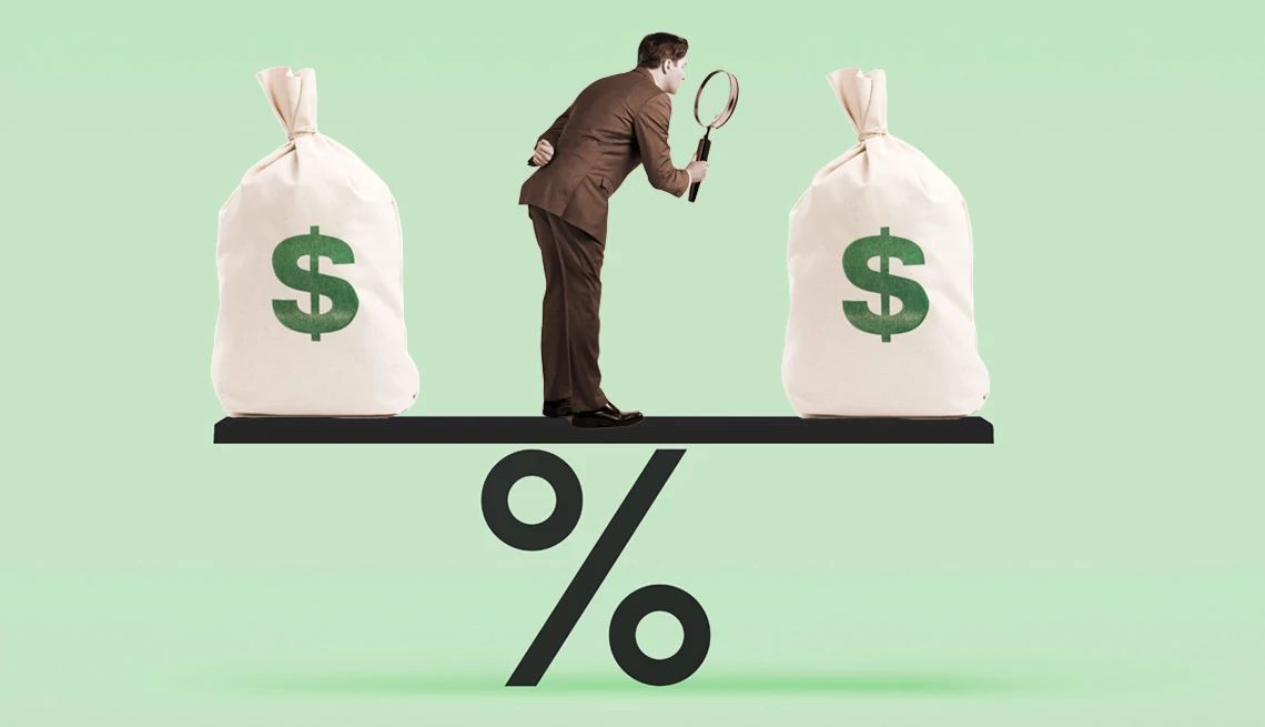 Fed interest rates a person looking at two bags of money on a precent sign shaped like a scale