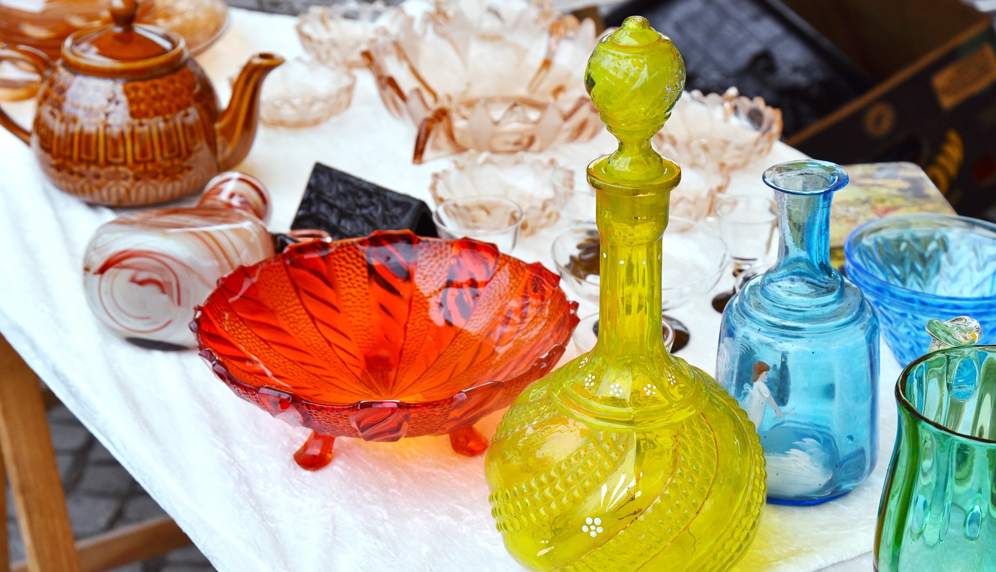 Power shopping at thrifts Set of glass decanter jugs, glassware vase and old vintage glassware on table