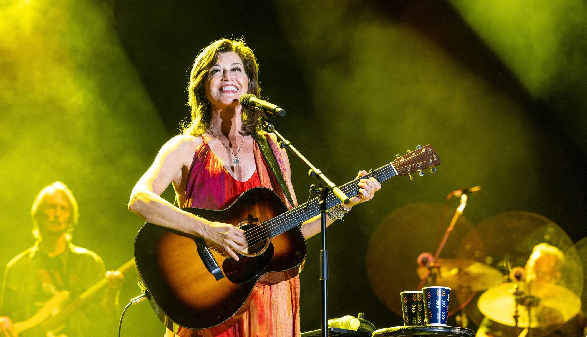 Amy Grant Amy Grant smiling as she plays her guitar onstage during the Summerfest Music Festival in Milwaukee