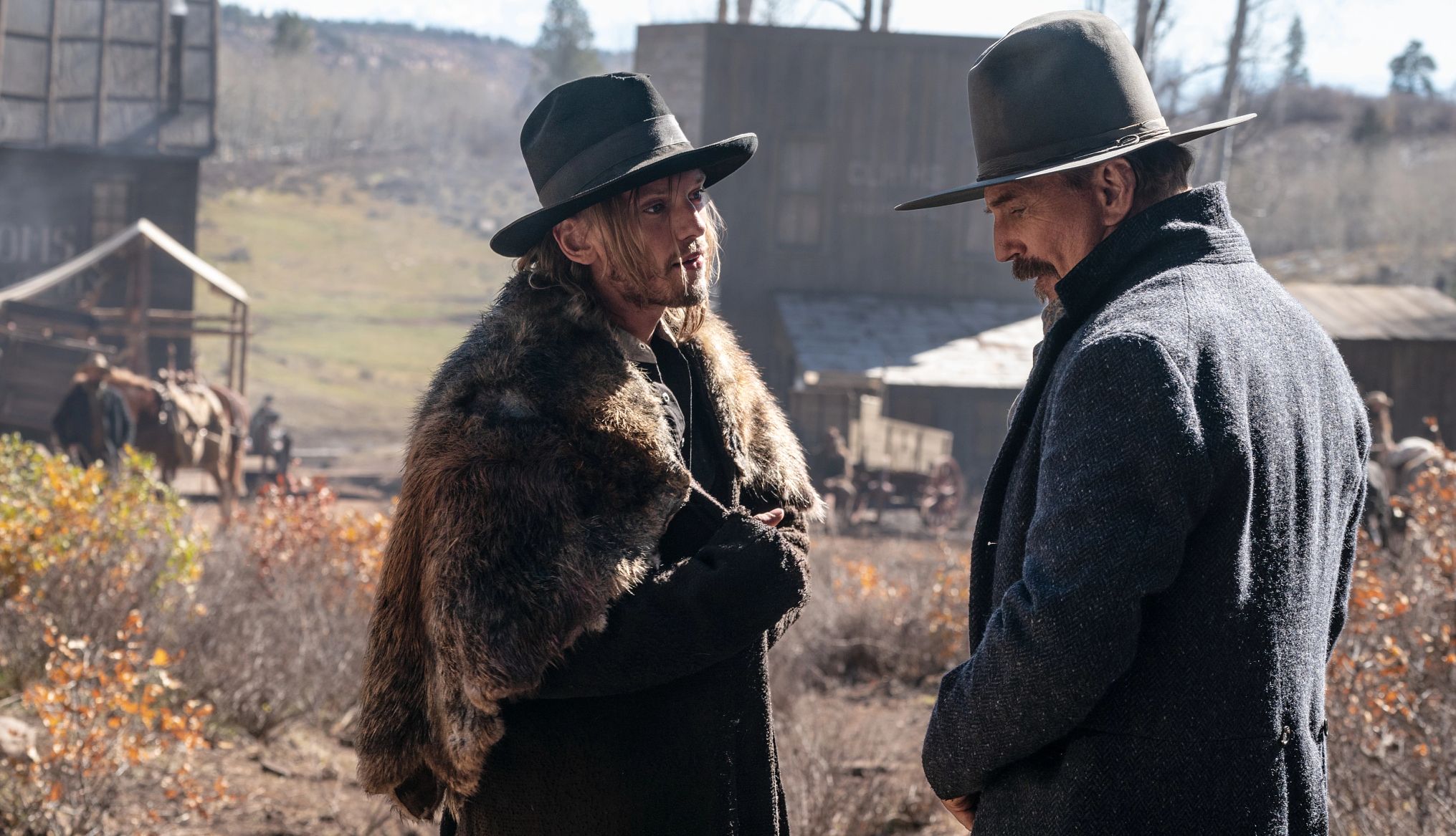 Jamie Campbell Bower and Kevin Costner in Horizon: An American Saga Jamie Campbell Bower and Kevin Costner talking to each other in a scene from the film Horizon: An American Saga