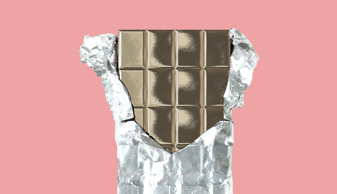 Heavy Metals Like Lead in Dark Chocolate close up of a chocolate bar unwrapped on a pink background