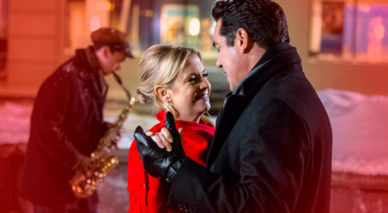 Movie still of Melissa Joan Hart and Dean Cain dancing from Hallmark's "Broadcasting Christmas"