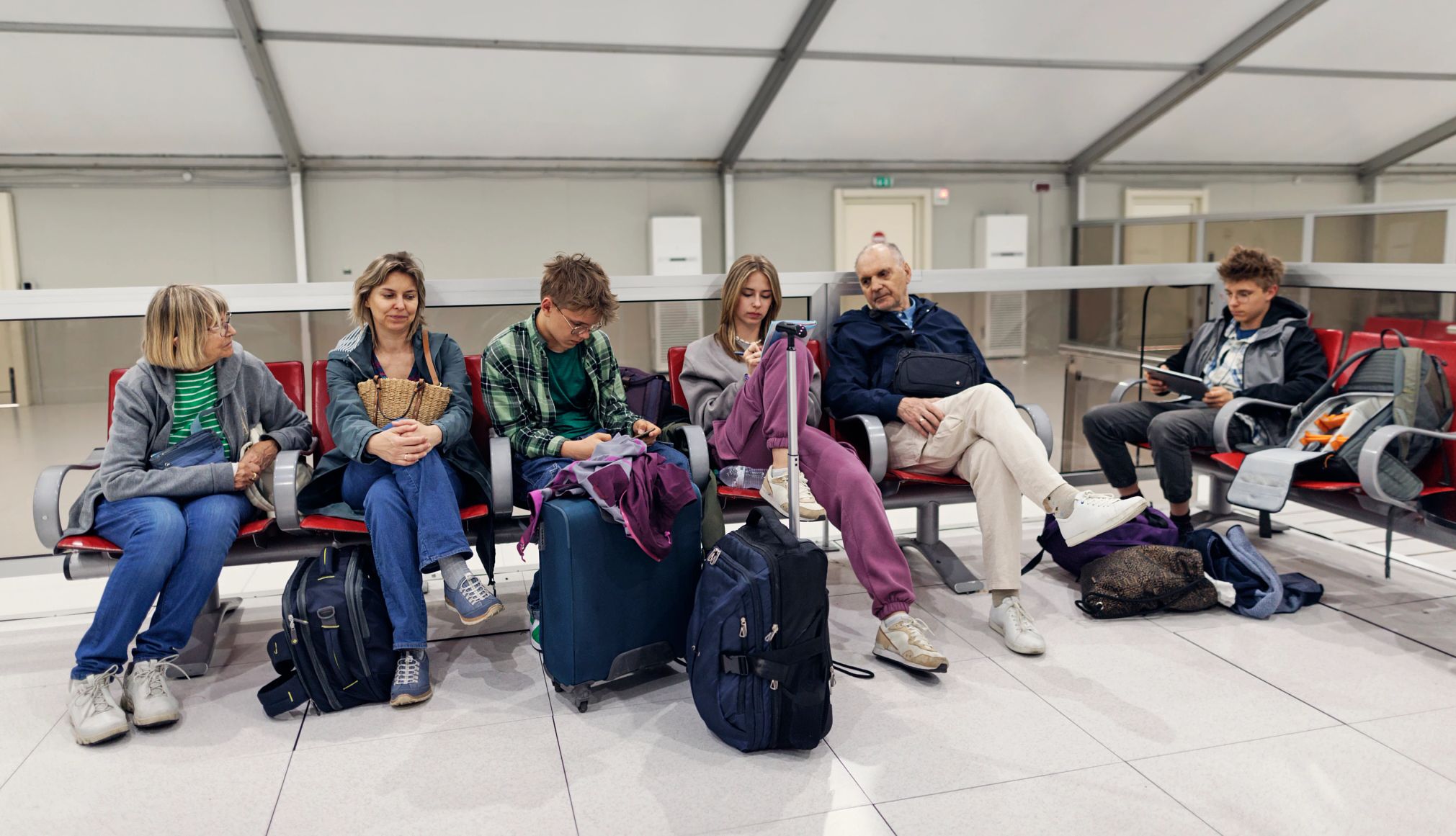 you may want to reconsider adding another leg to an already long trip a multigen family waiting at an airport gate