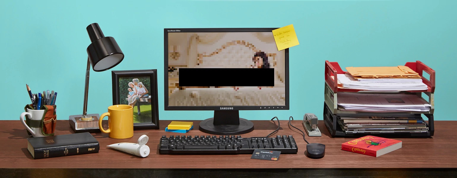 A photo of a seemingly normal work desk, but the computer has a lewd chatroom website on.
