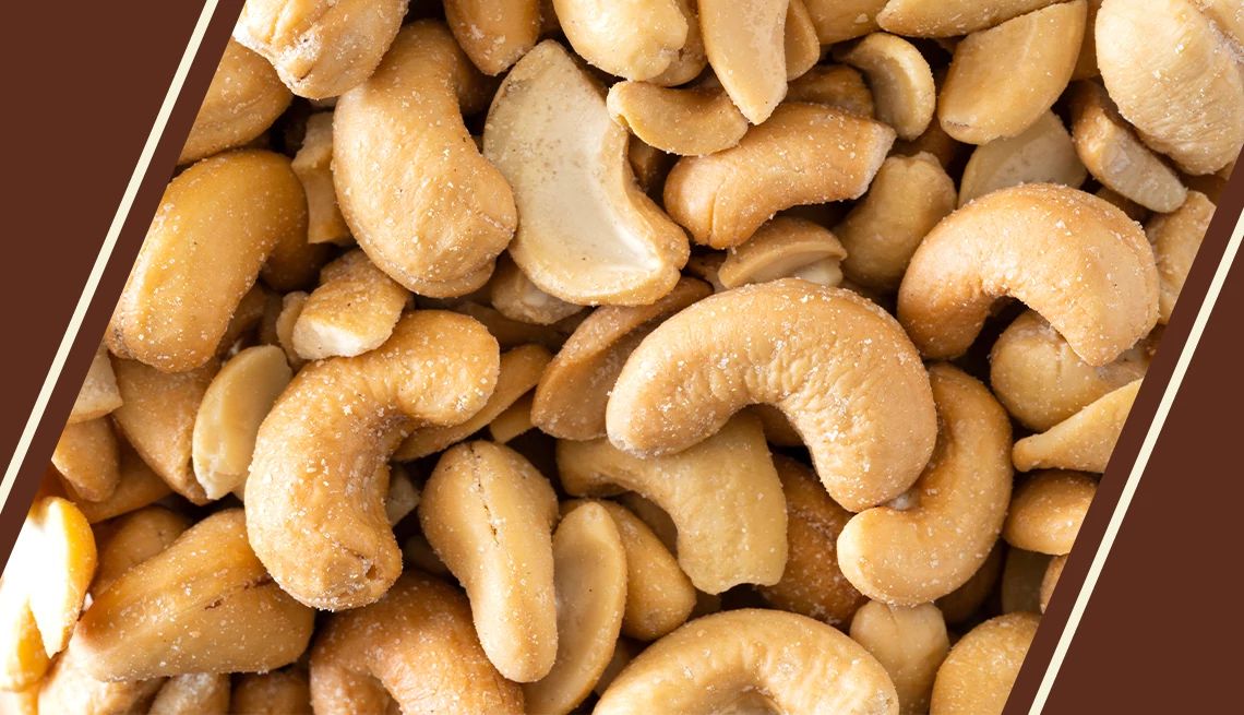 A tray of cashews on a light brown background Cashews in Container