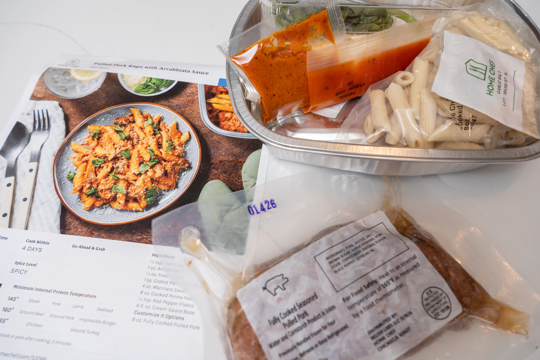 A Home Chef meal kit on a counter next to the recipe card