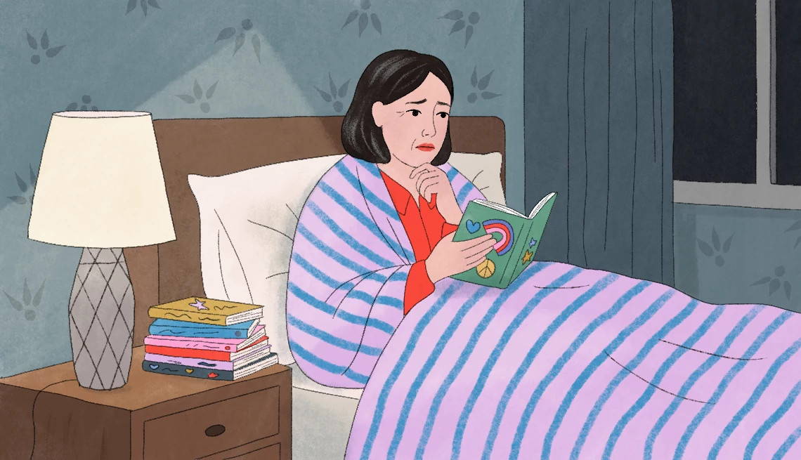 a woman laying in bed reading childhood journals