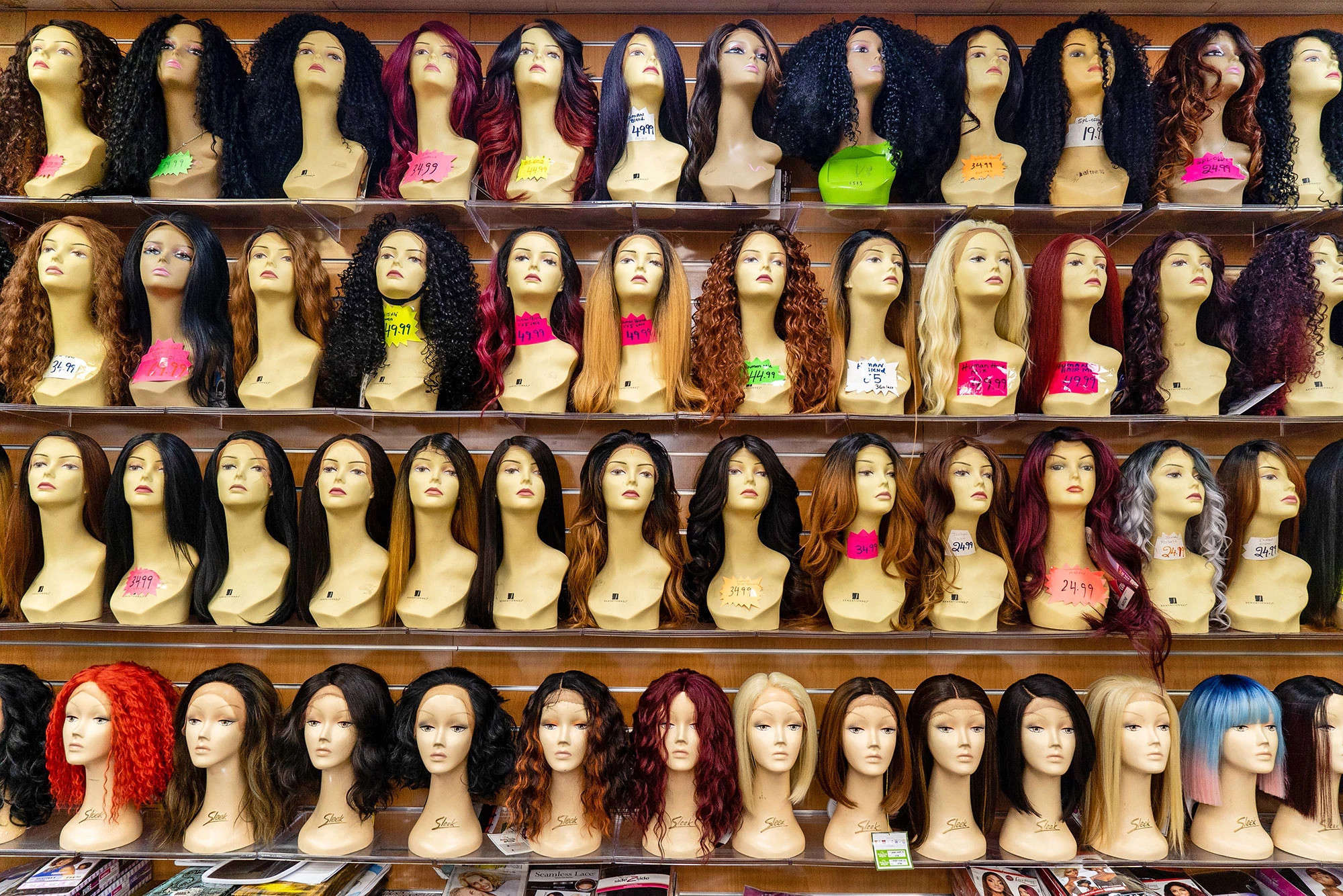 Mannequins with wigs on a shelf