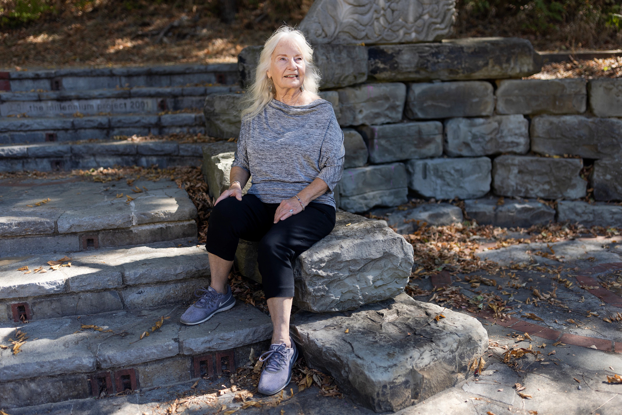 a woman sitting in a park