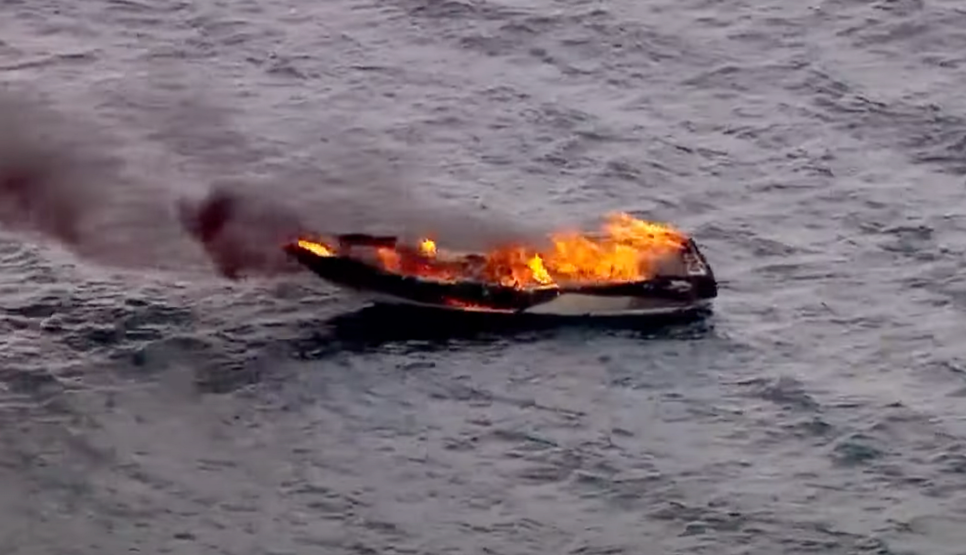 Cousins, Teens Make Heroic Boat Rescue A photo shows a boat on fire in Lake Michigan