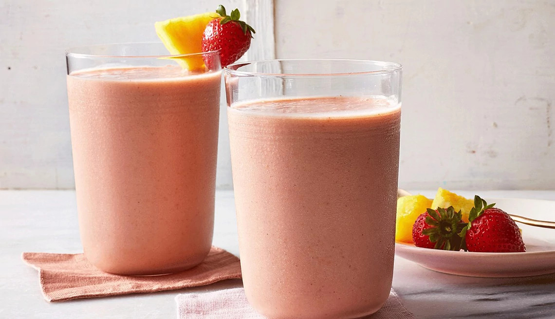 A close-up view of strawberry-pineapple smoothie in glasses