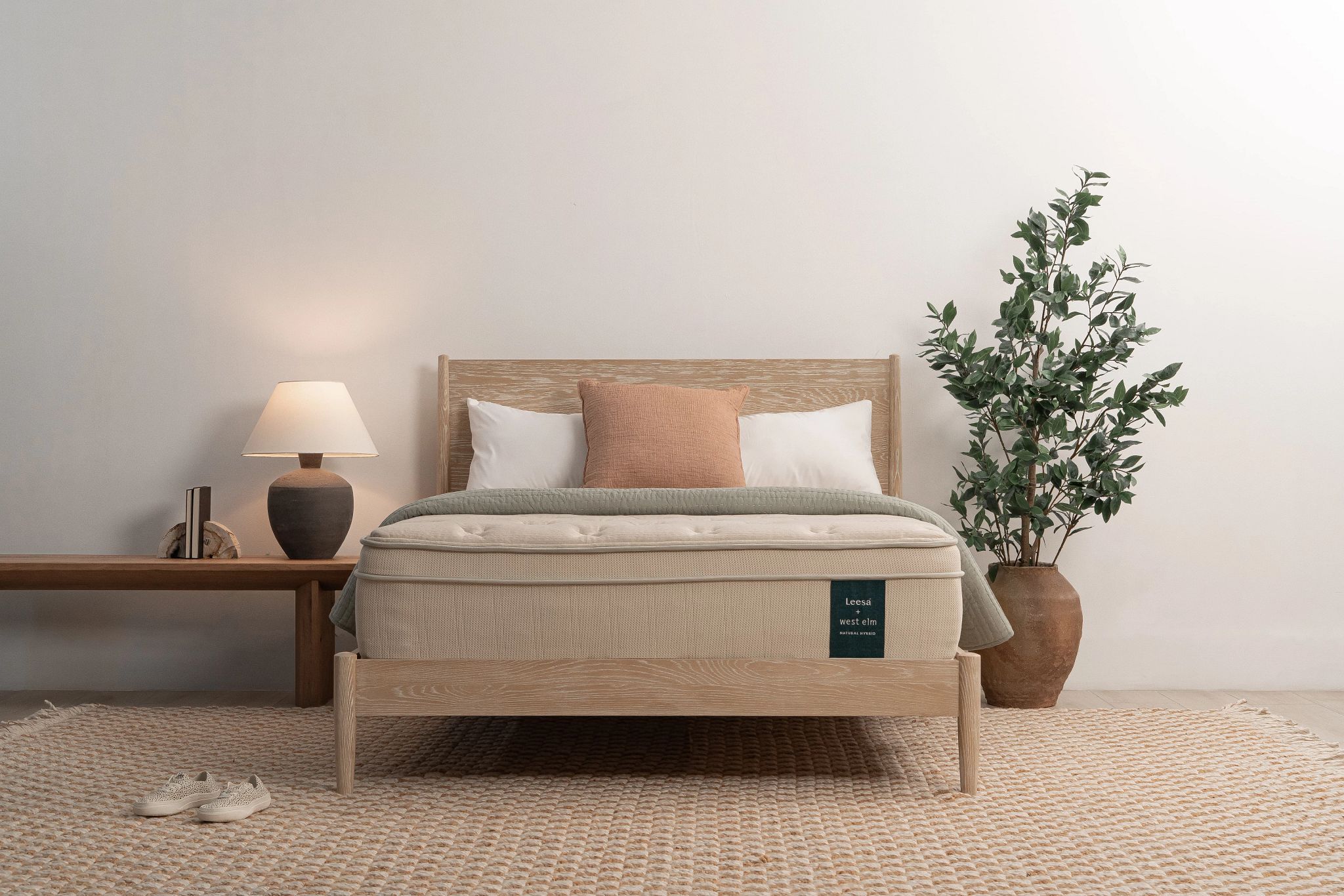 The Leesa Natural mattress in a bedroom with a plant