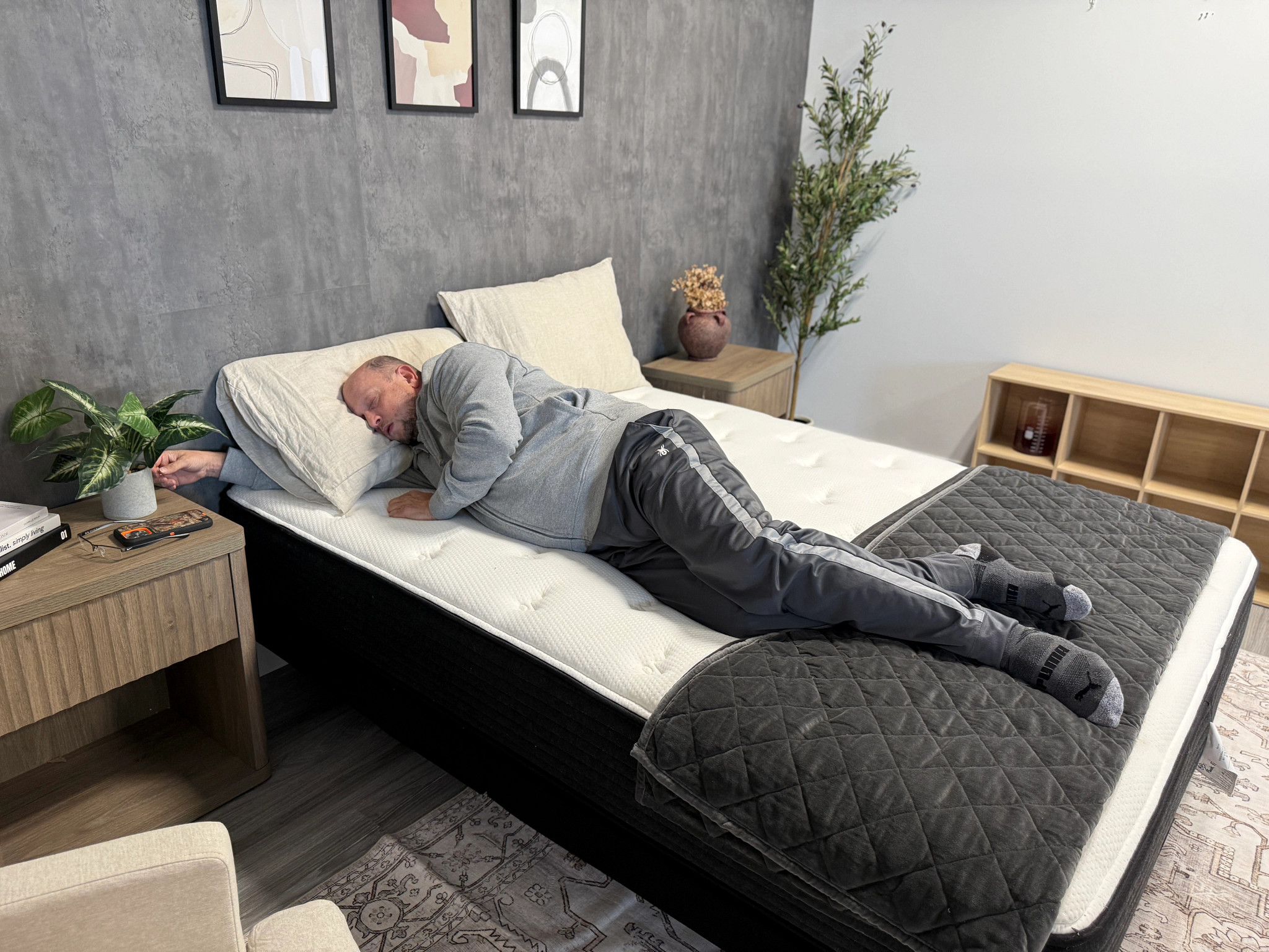 Man lies on his side with his eyes closed in bed