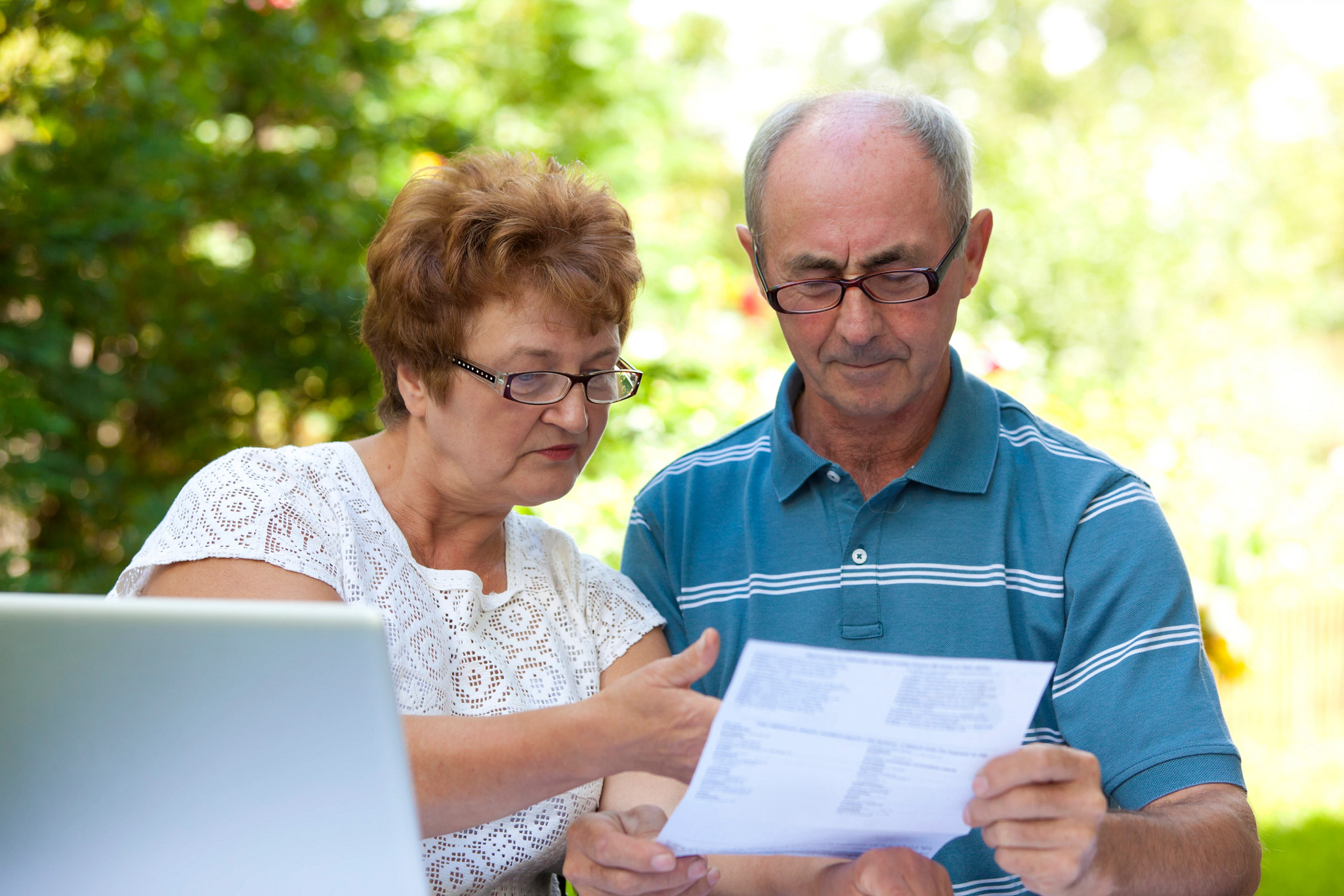 two people looking at a sheet of paper
