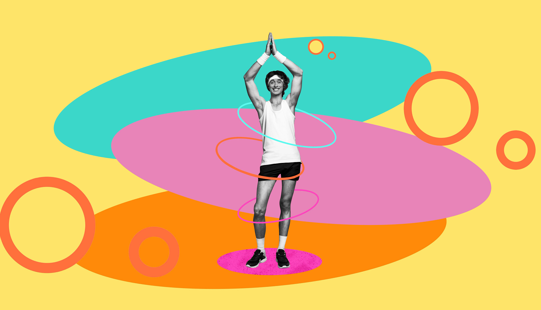 A smiling man with his arms raised above his head and three hula hoops around his body on a creative background.