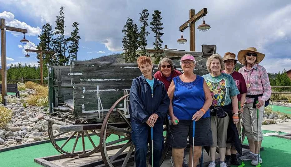 a group of women posing at a mini golf course