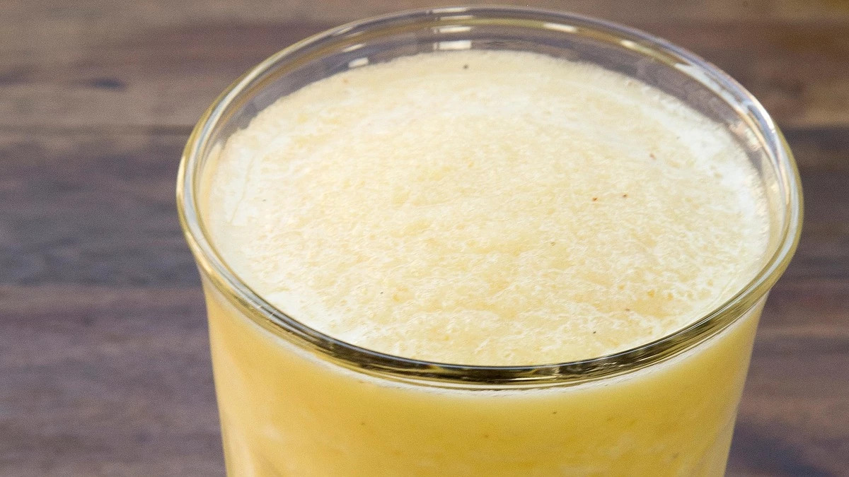 A close-up view of pineapple smoothie in a glass