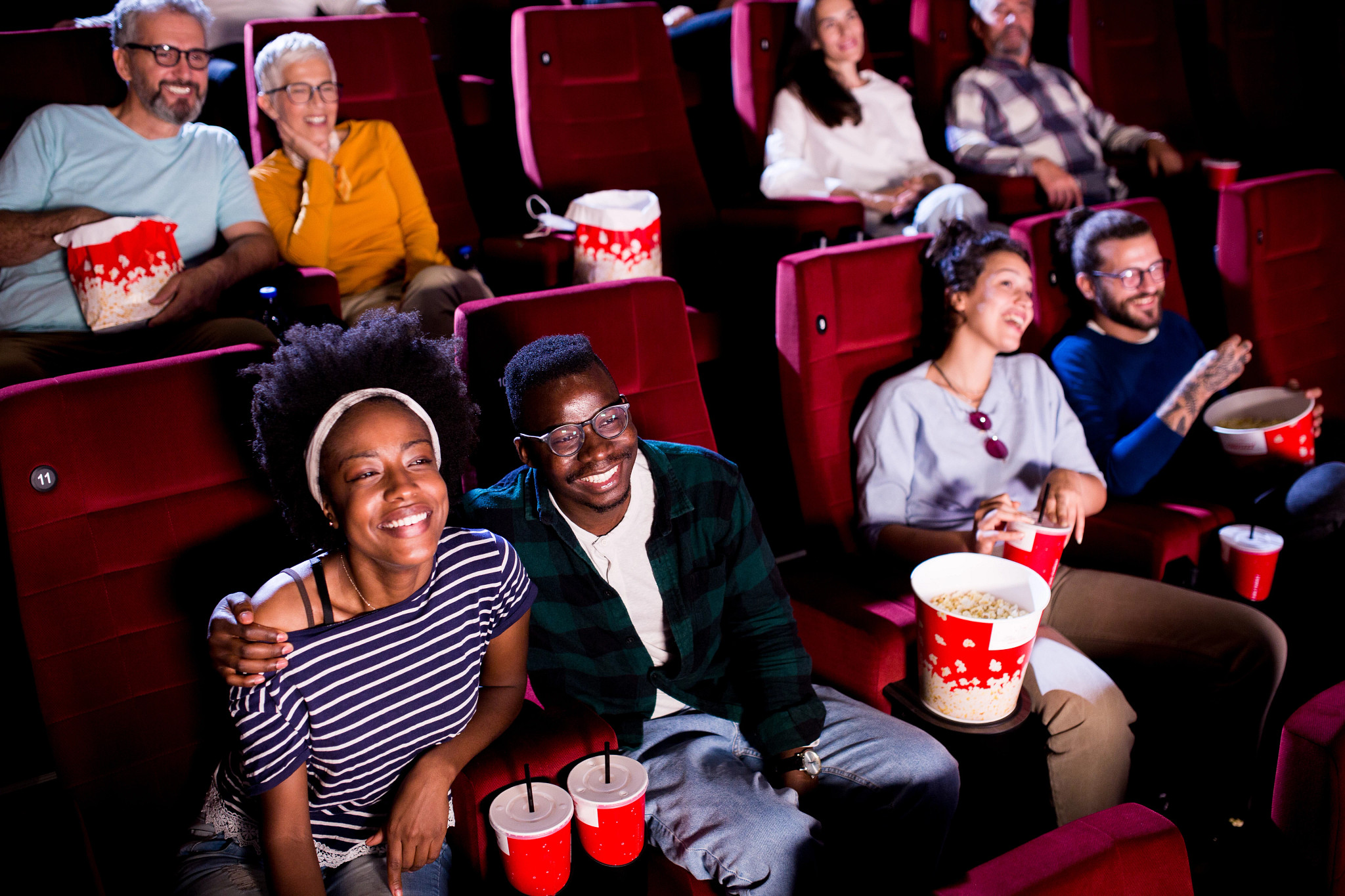 Couples watching a romantic movie at the cinema and enjoying