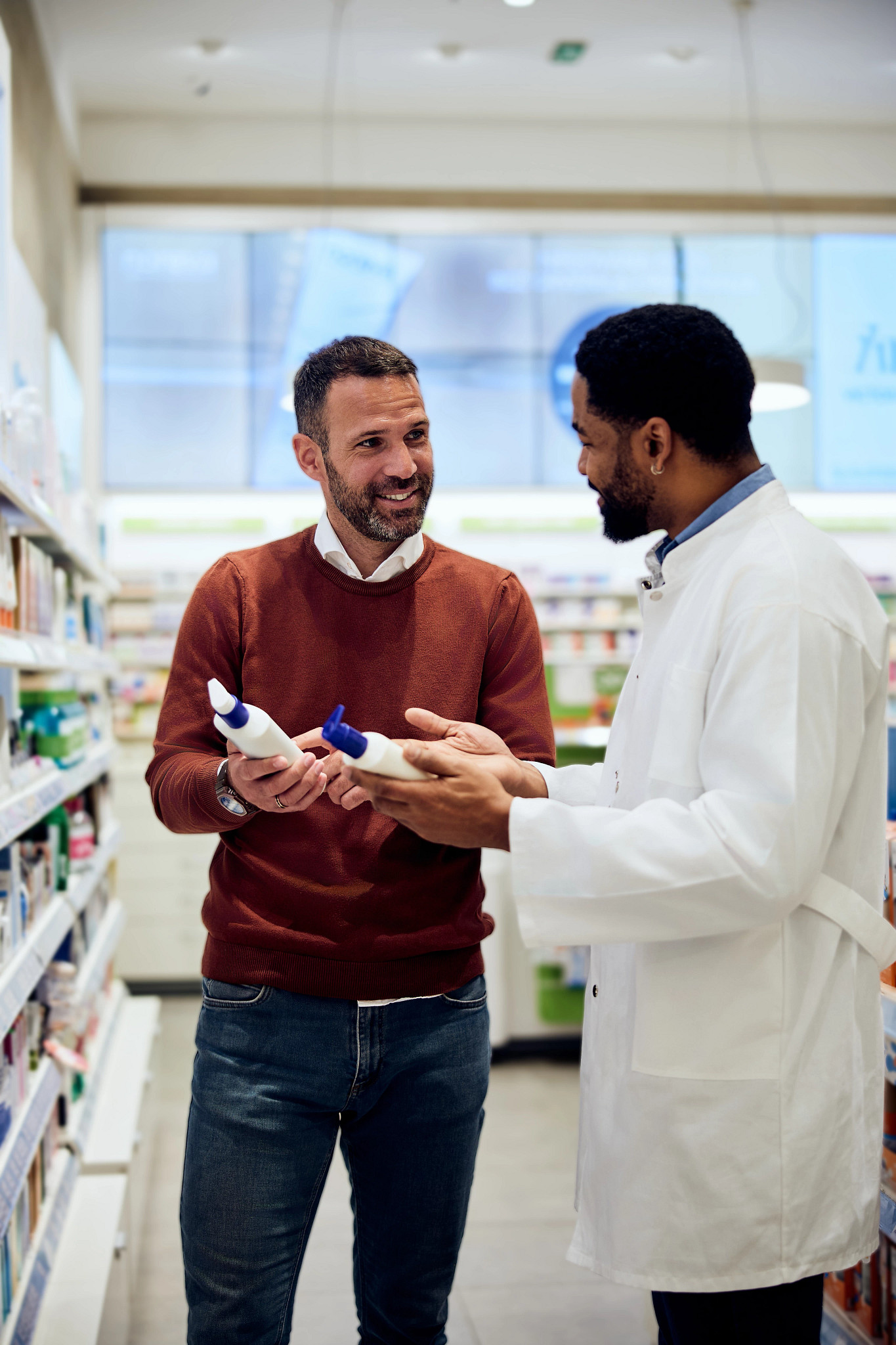 Customer and Pharmacist Discussing Product in a Pharmacy Aisle