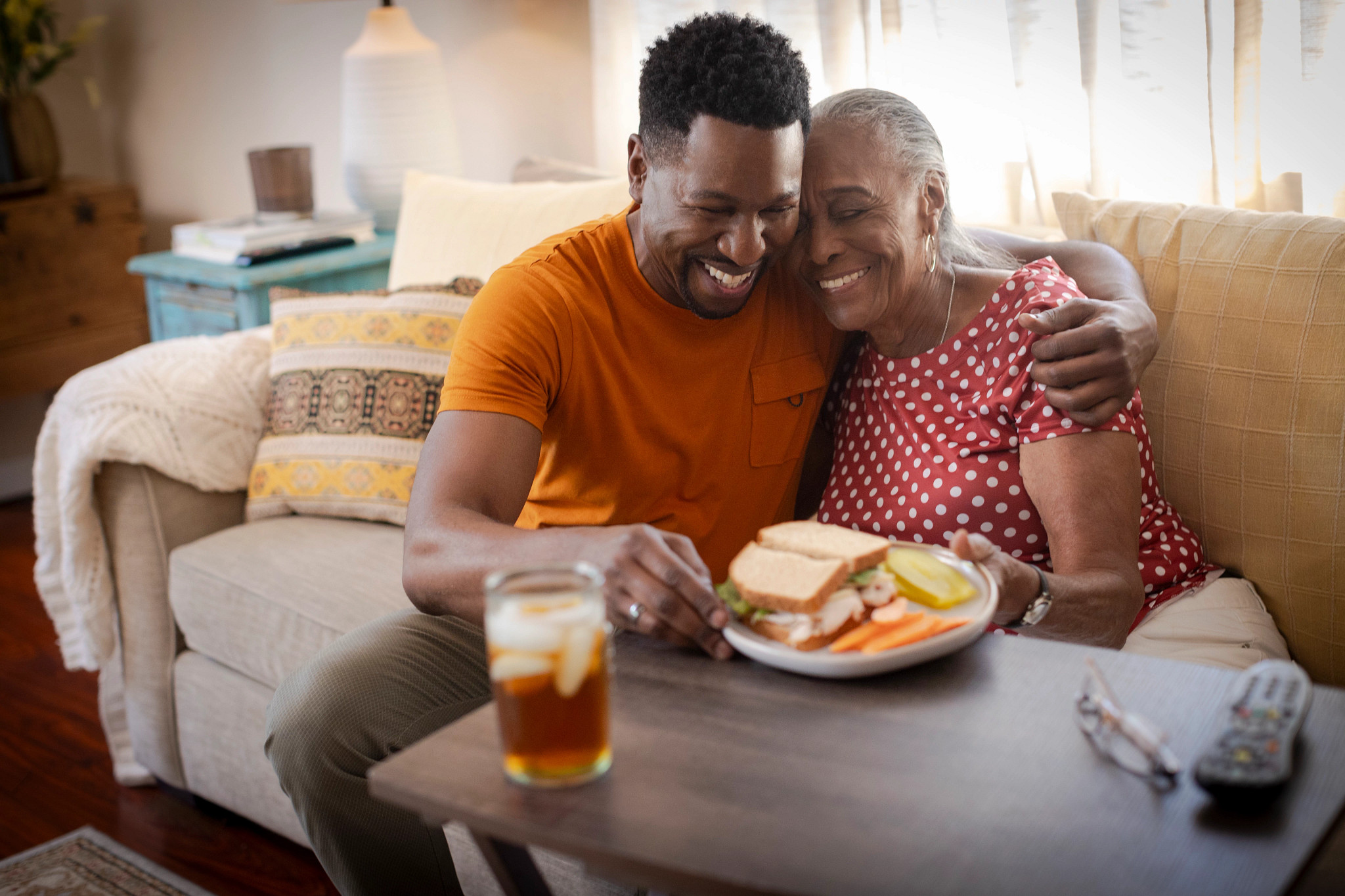 Son assists mother with meal at home