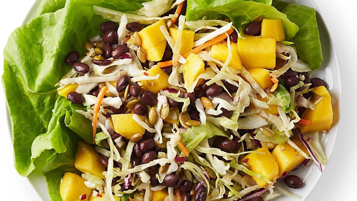 A close-up view of a black and bean mango salad in a bowl