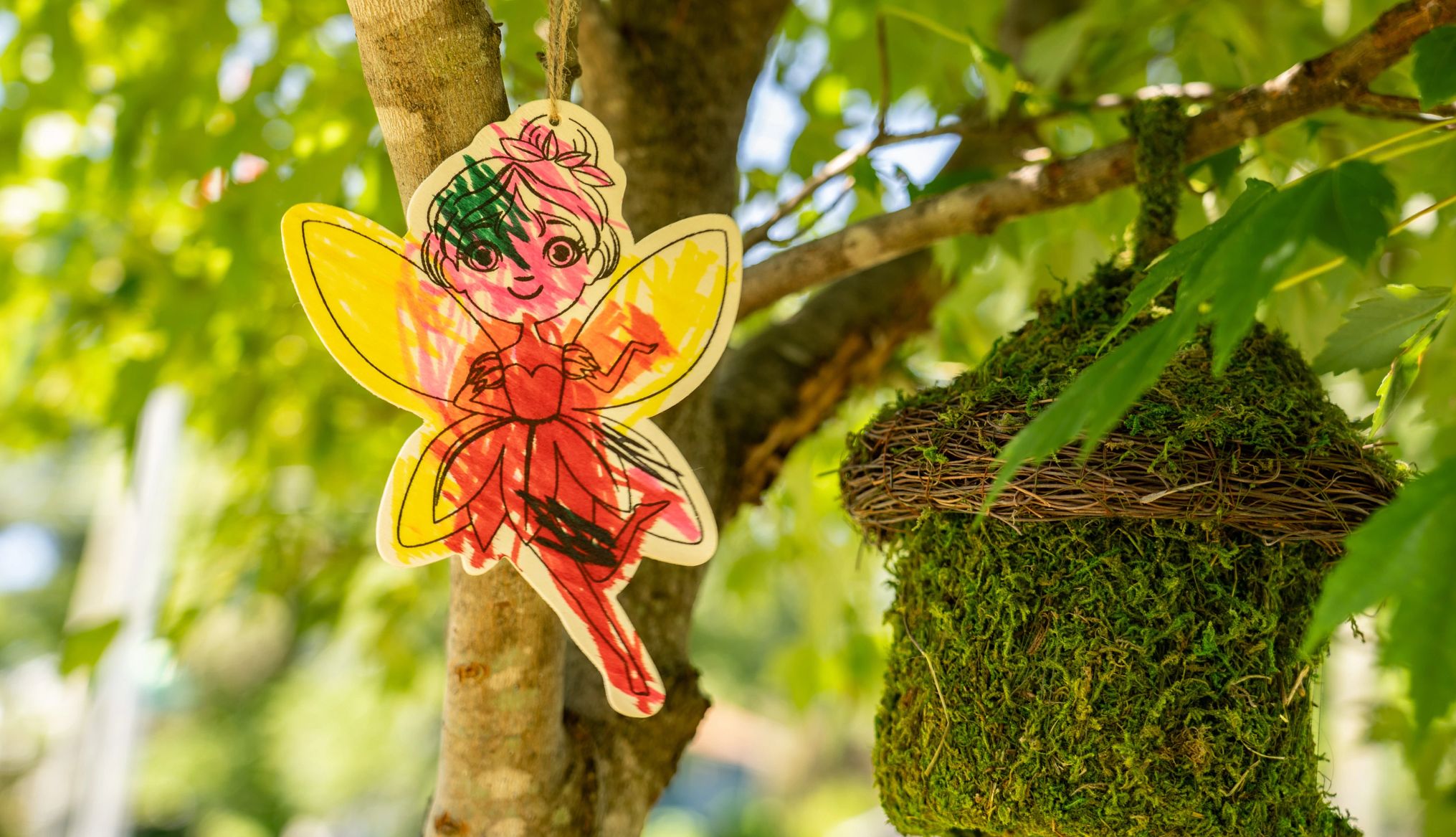 How to create a fairy garden a cutout of a fairy hangs in a tree