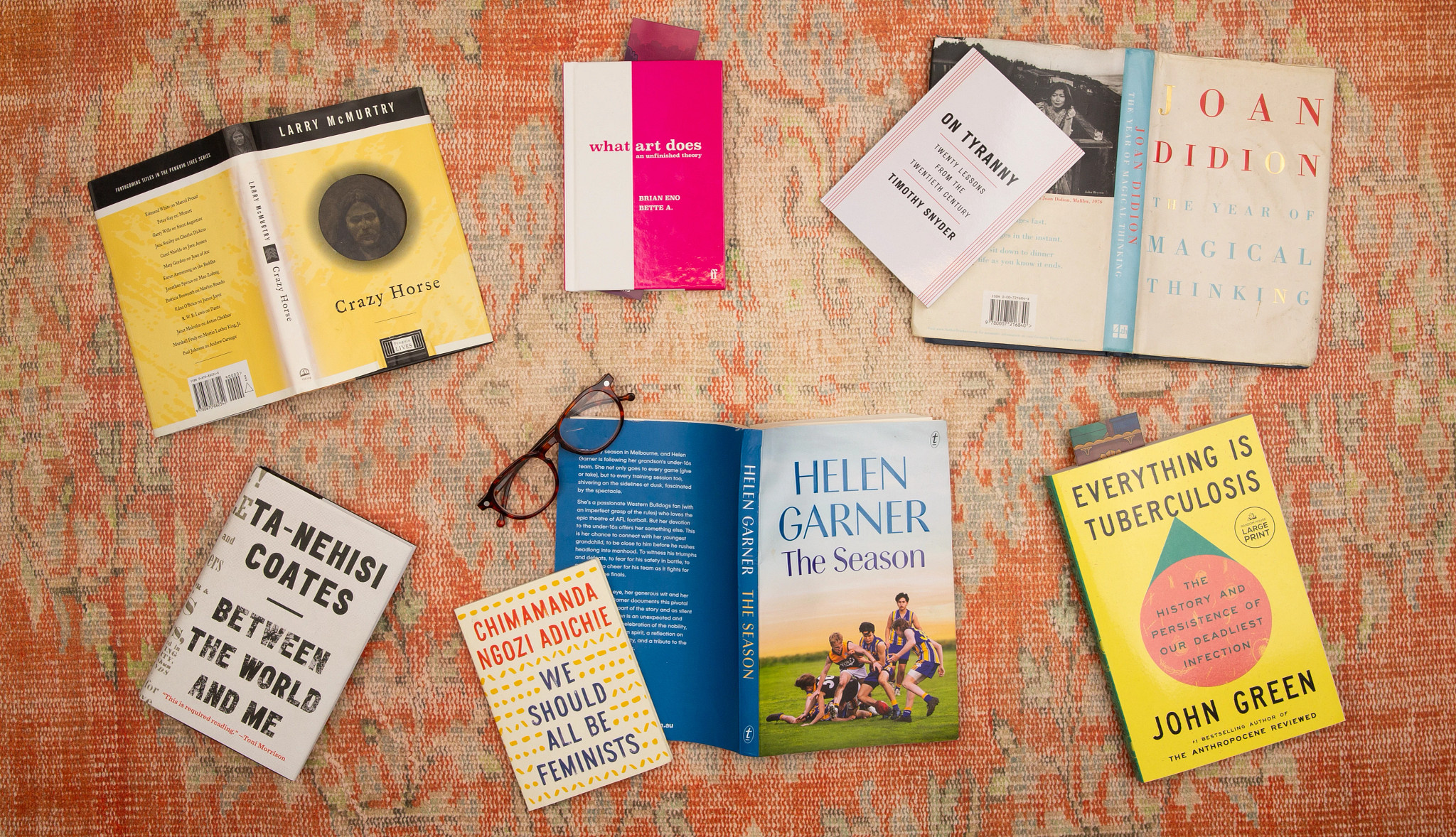 a collection of nonfiction books spread across a colorful woven cloth