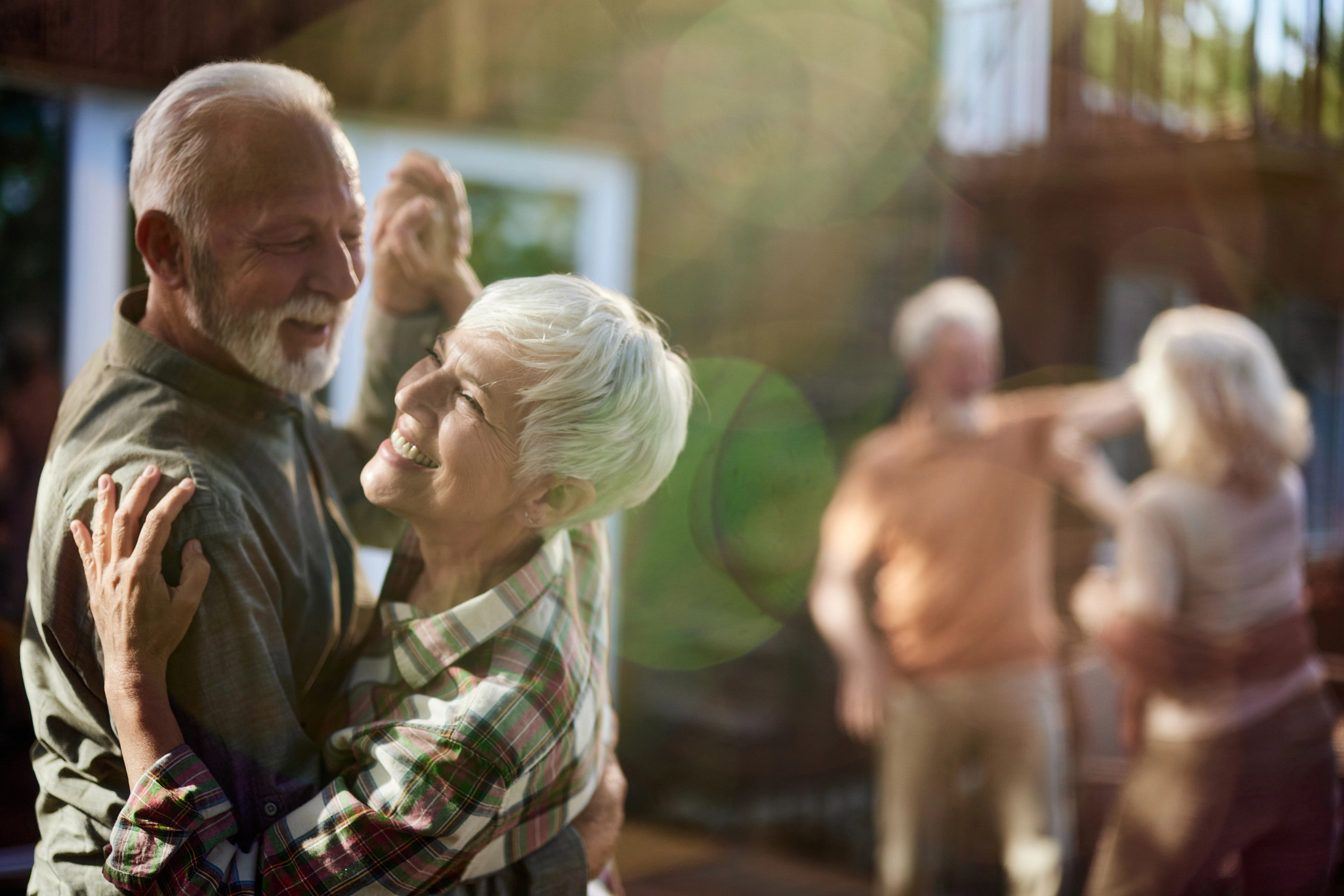 Smiling older couple outdoors representing the benefits of AARP membership 	