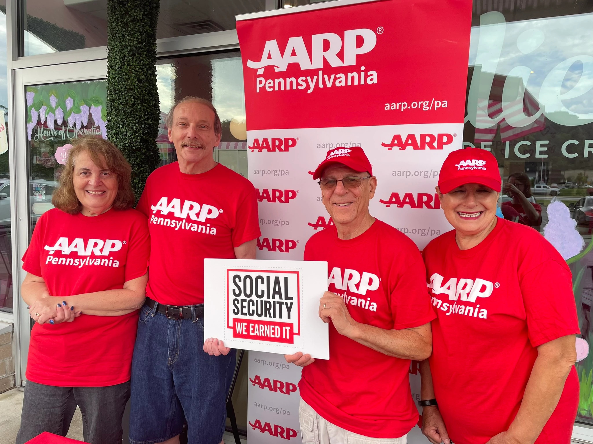 A group of a a r p pennsylvania volunteers holding up a "social security we earned it sign"
