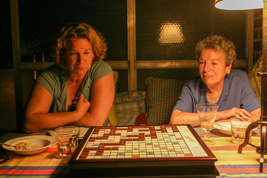 A photos shows Caitlin Kelly and her mother Cynthia playing a board game in 2006 on the author's balcony in New York.