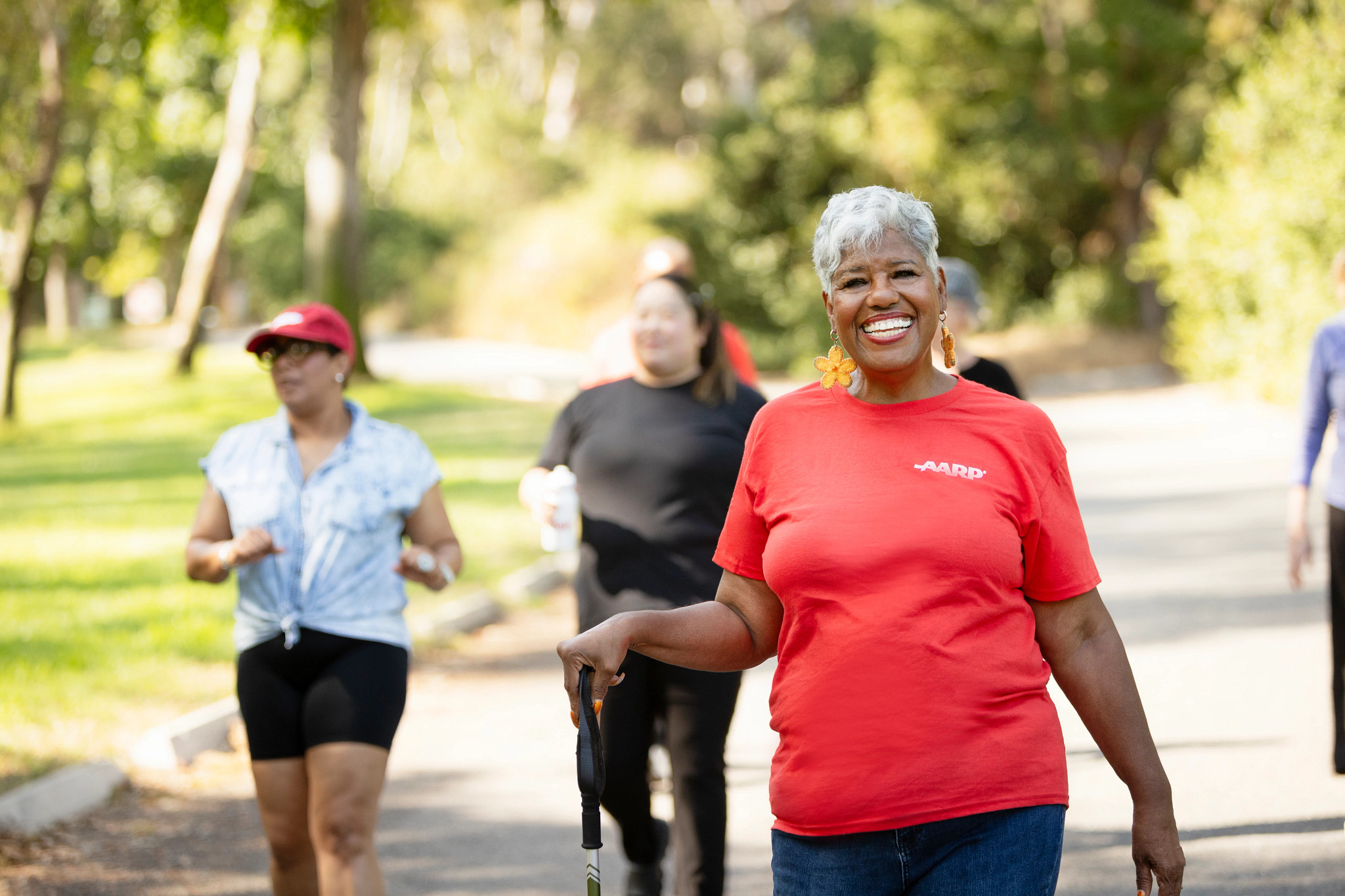 Happy woman and friends on walk in community