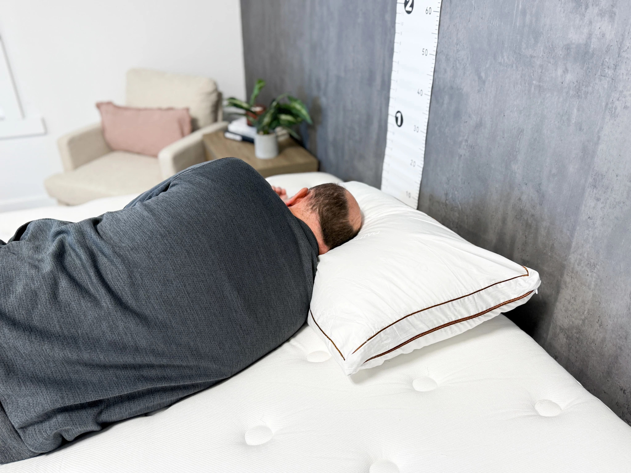 A man lying on his side on the Saatva Latex Pillow