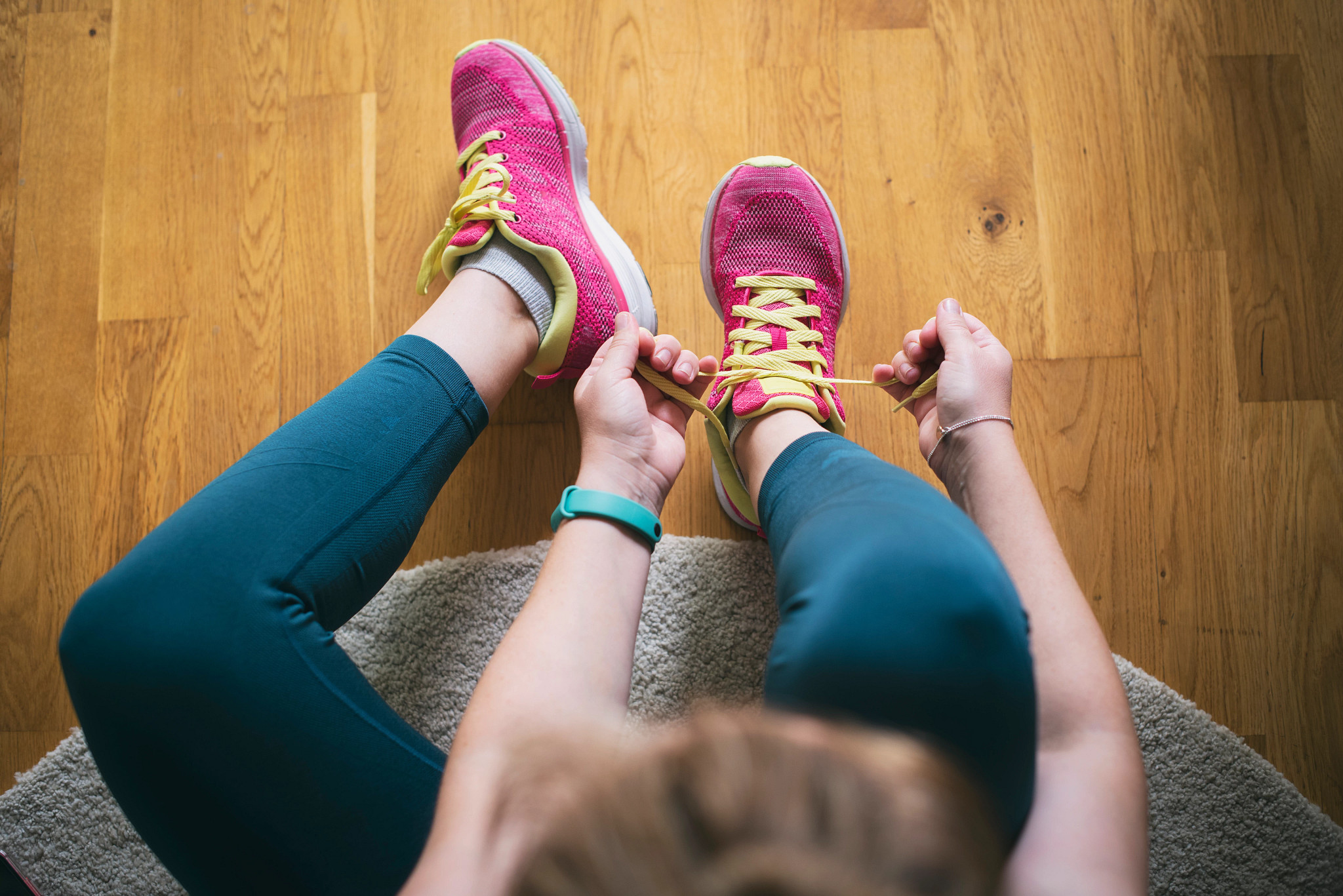 A person tying their sneakers before starting an exercise session