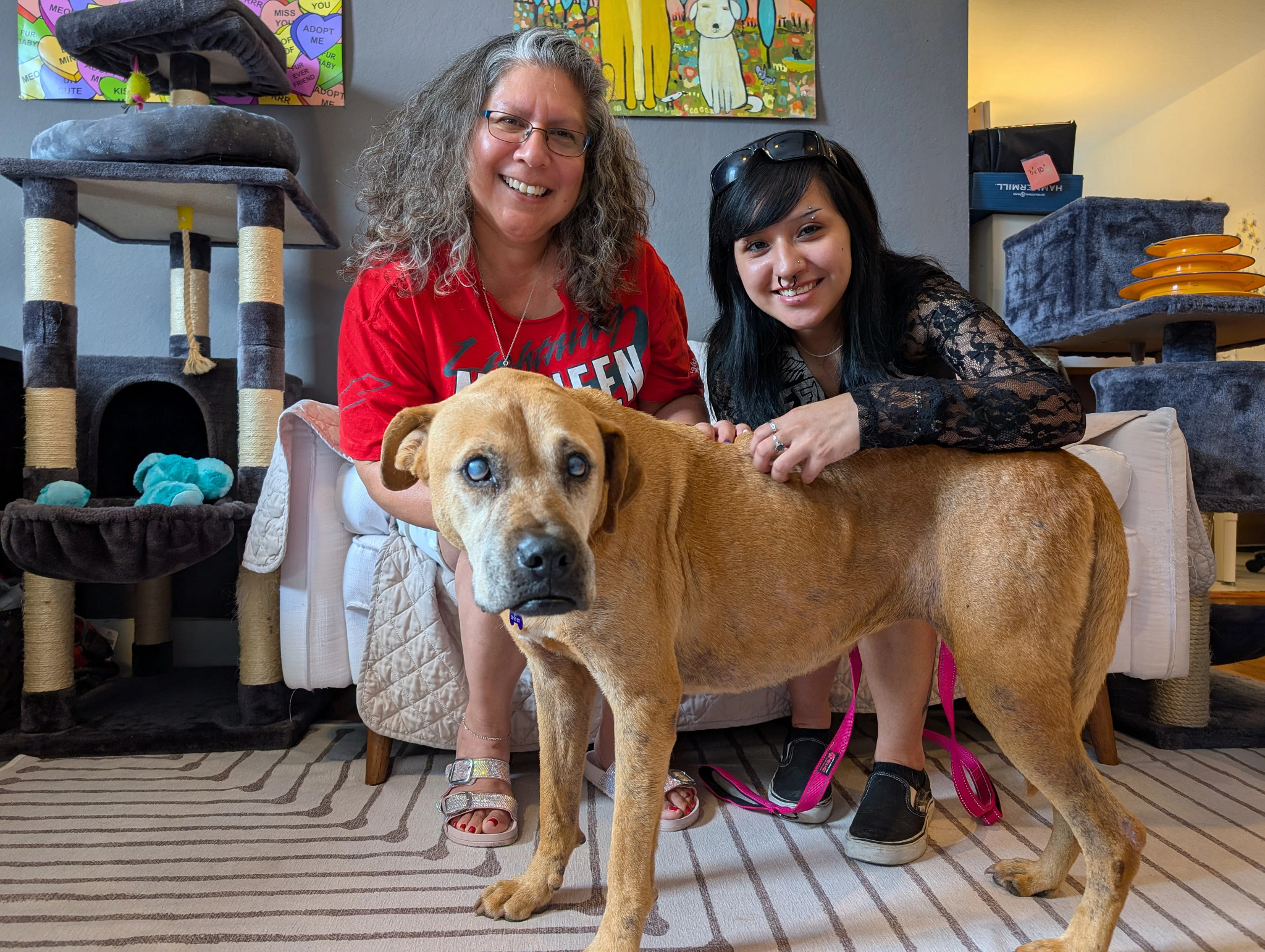 a photo shows Juliette Gonzalez with her dog Sandy and her daughter Jia 