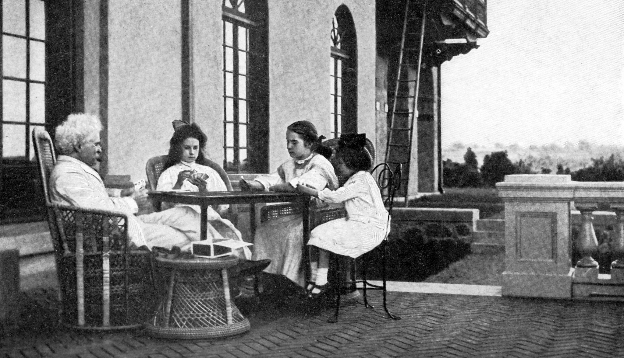 13 Fascinating Facts About Mark Twain Mark Twain, playing cards at an outdoor table with three young girls in white dresses