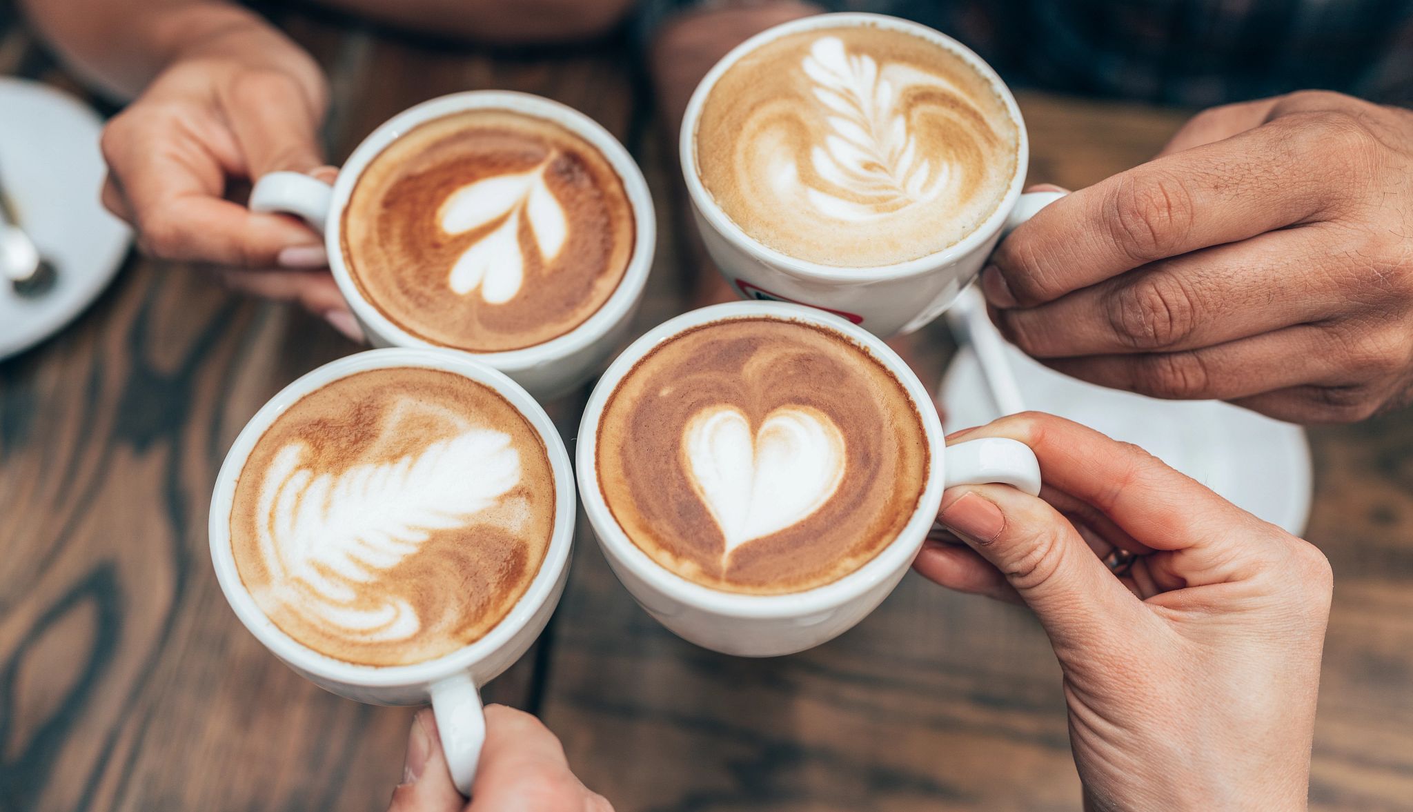 People hands holding cups of cappuccino. Friends drinking coffee together. Hands holding modern looking cups of cappuccino. Tasty and good looking coffee. People hands holding cups of cappuccino. Friends drinking coffee together. Hands holding modern looking cups of cappuccino. Tasty and good looking coffee.