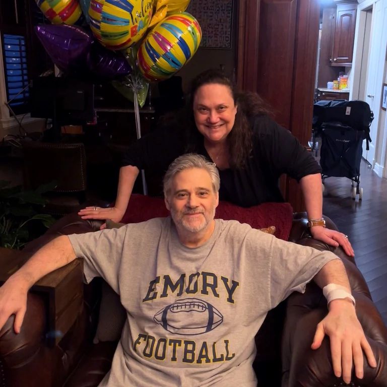 Organ transplant caregiver flo and ricky dessen smile at the camera