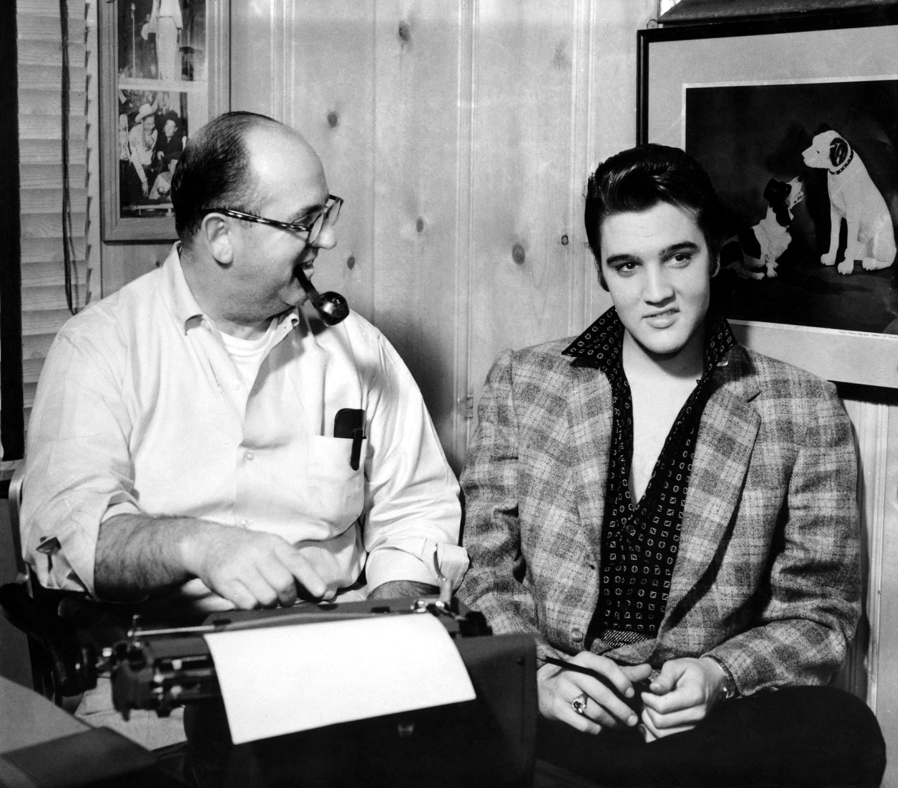 A New Look at the Man Who Managed Elvis colonel tom parker sitting beside elvis presley