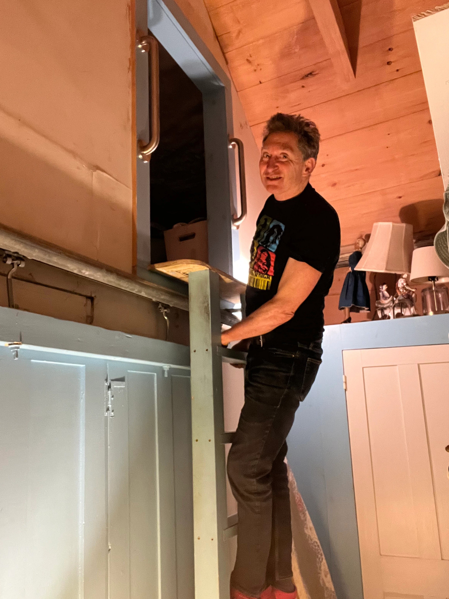 a photo shows author Bill Donahue heading to the attic where he stores his family archives.
